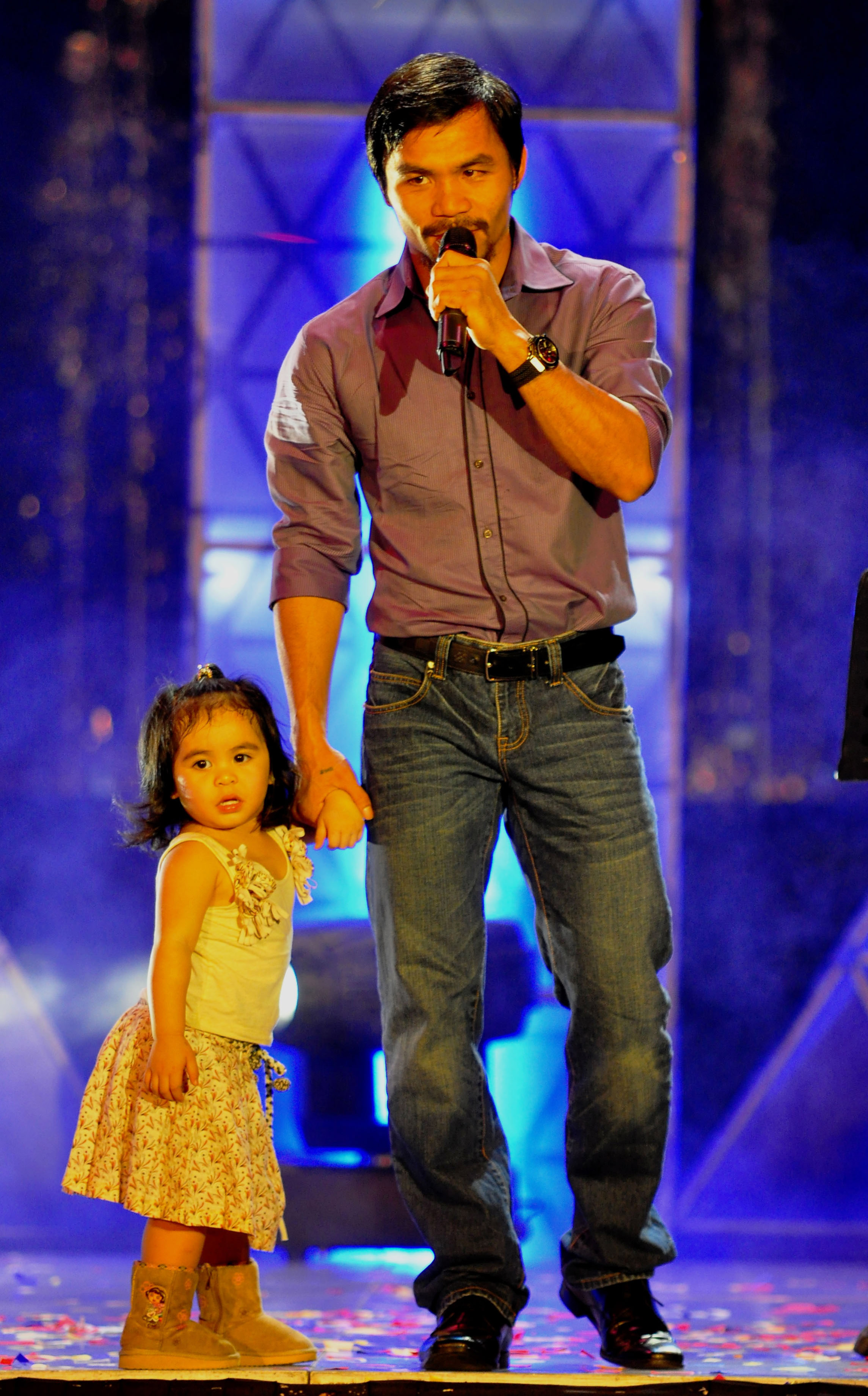 MANILA, PHILIPPINES - NOVEMBER 20:  Boxer and congressman, Manny Pacquiao sings with youngest daughter Queen Elizabeth during his concert in Manila following his win of the WBC super welterweight crown against Mexican Antonio Margarito on November 20, 201