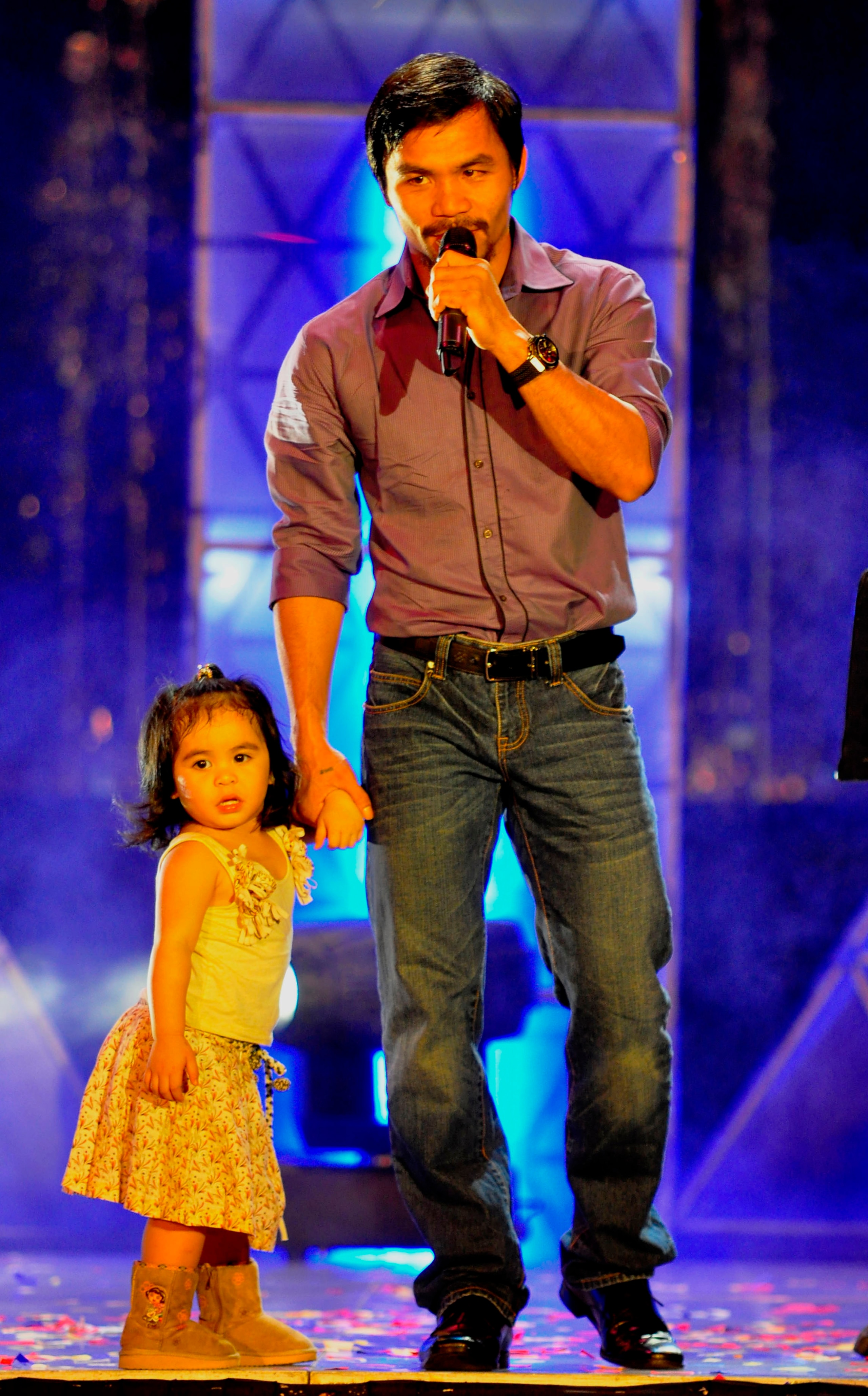 MANILA, PHILIPPINES - NOVEMBER 20:  Boxer and congressman, Manny Pacquiao sings with youngest daughter Queen Elizabeth during his concert in Manila following his win of the WBC super welterweight crown against Mexican Antonio Margarito on November 20, 201