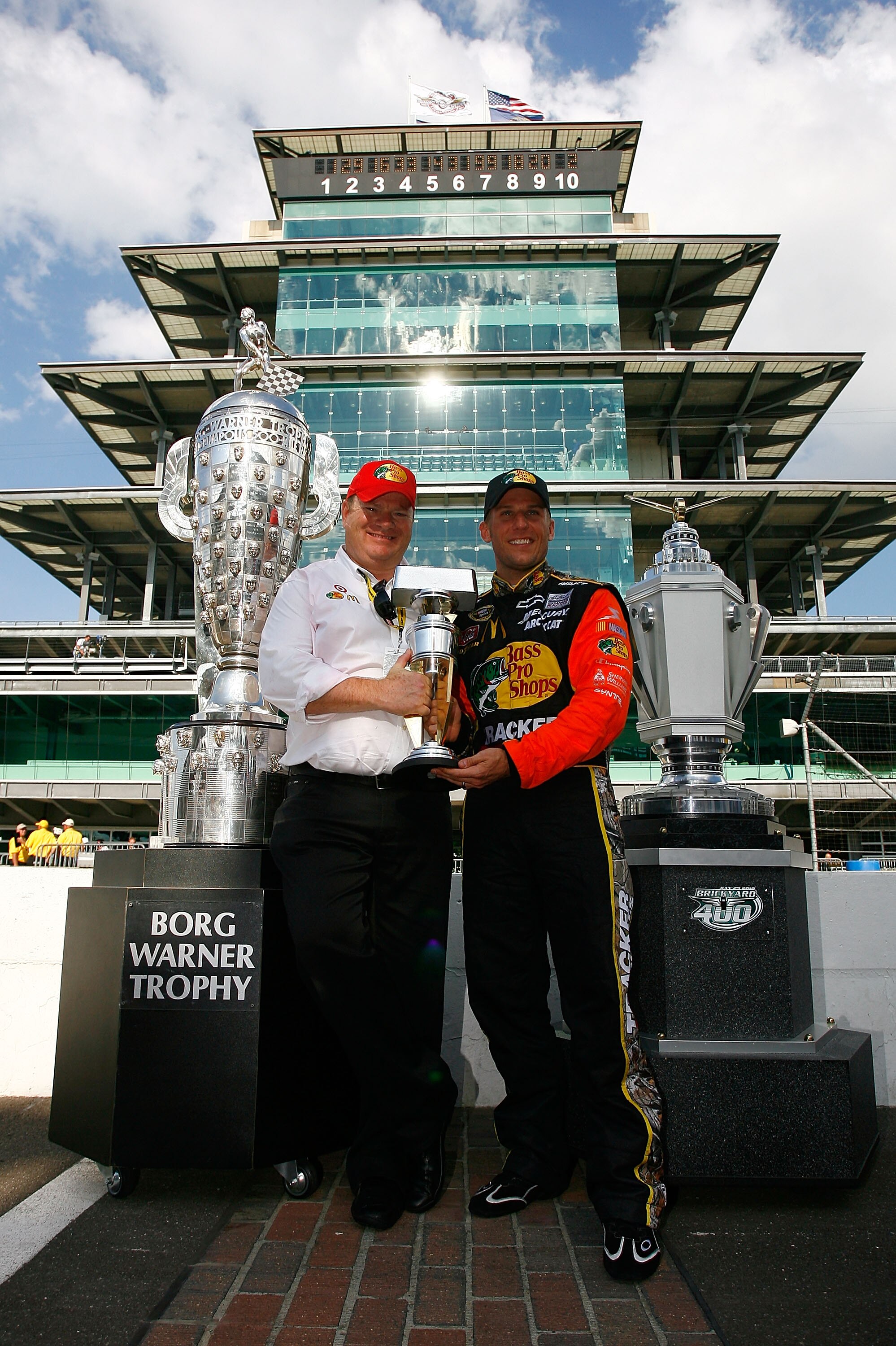 INDIANAPOLIS - JULY 25:  (L-R) Team co-owner Chip Ganassi and Jamie McMurray, driver of the #1 Bass Pro Shops/Tracker Boats Chevrolet, pose with the Brickyard 400 Trophy after winning the NASCAR Sprint Cup Series Brickyard 400 at Indianapolis Motor Speedw