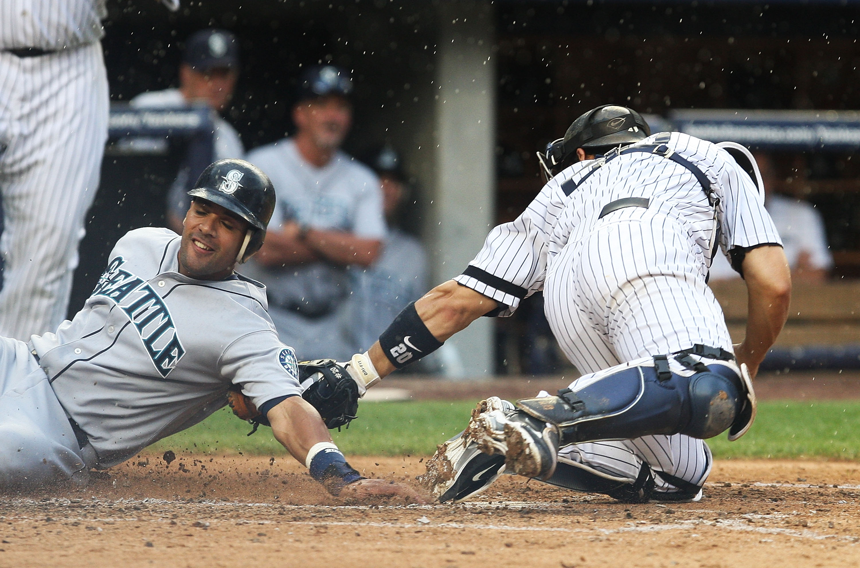 NEW YORK - AUGUST 22:  Franklin Gutierrez #21 of the Seattle Mariners is tagged out at home by Jorge Posada #20 of the New York Yankees in the fifth inning on August 22, 2010 at Yankee Stadium in the Bronx borough of New York City.  (Photo by Andrew Burto