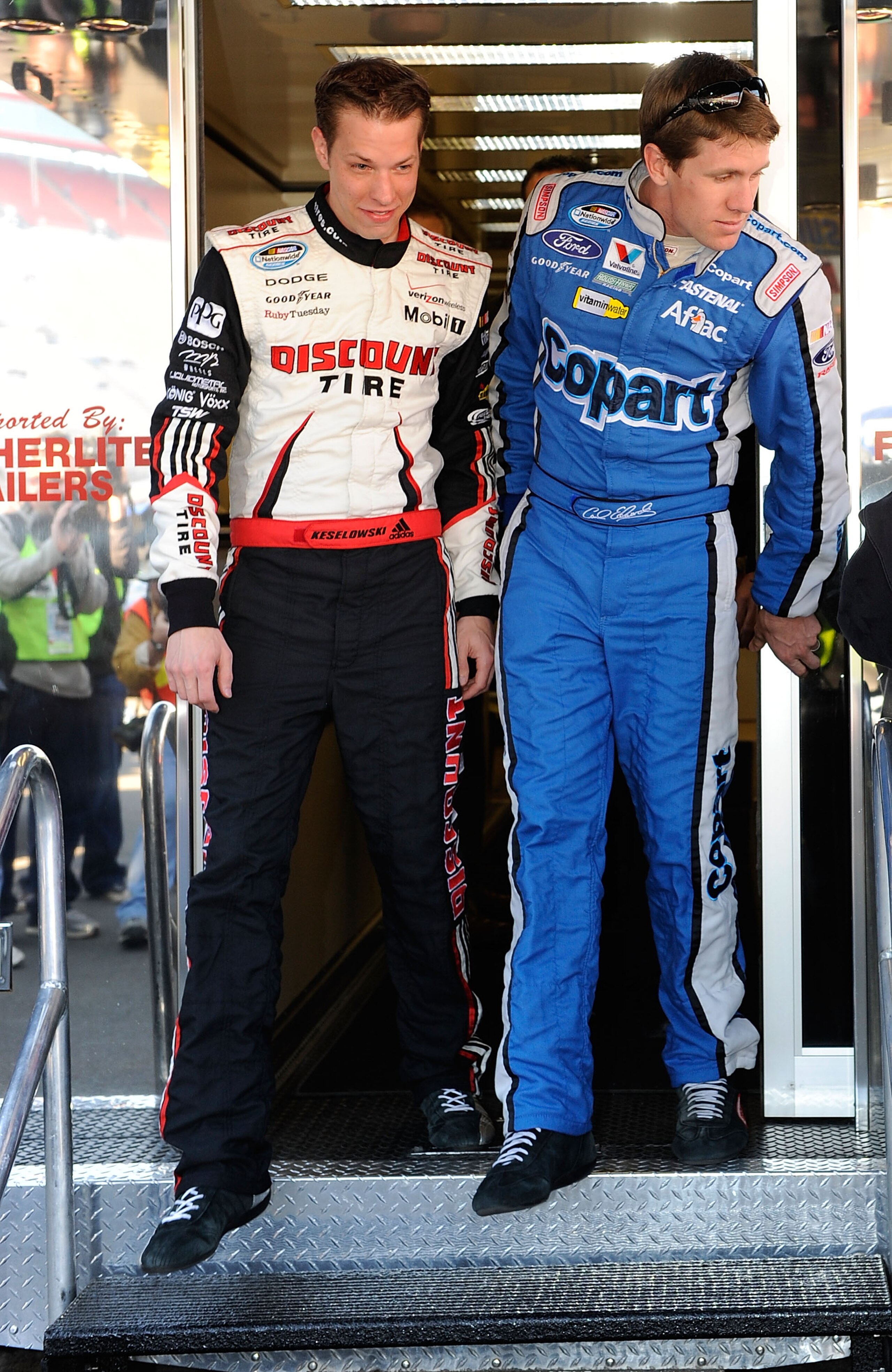 BRISTOL, TN - MARCH 20:  Carl Edwards (R), driver of the #60 COPART Ford, and Brad Keselowski, driver of the #22 Discount Tire Dodge, walk out of the NASCAR hauler at Bristol Motor Speedway on March 20, 2010 in Bristol, Tennessee.  (Photo by Rusty Jarrett