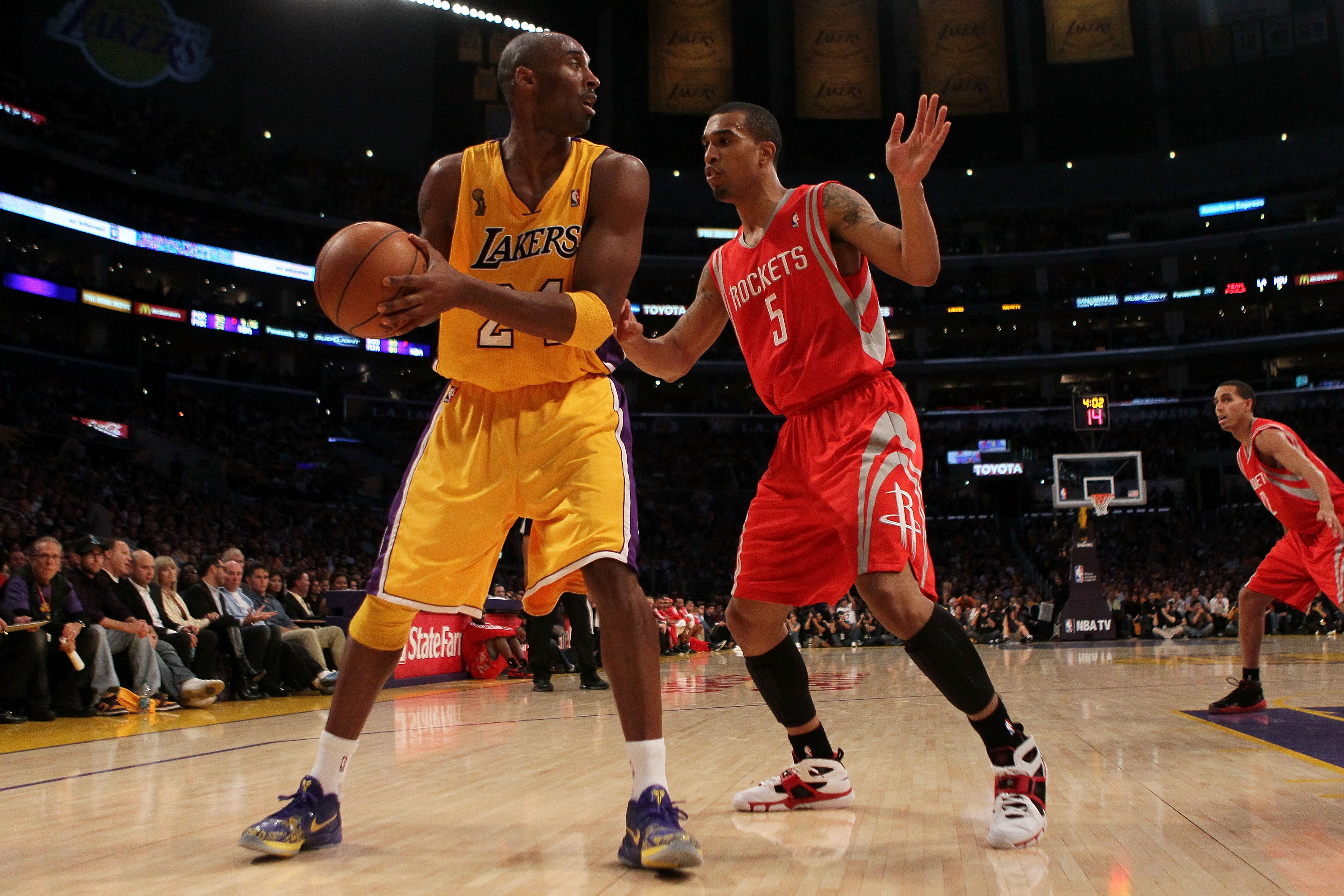 LOS ANGELES, CA - OCTOBER 26:  Kobe Bryant #24 of the Los Angeles Lakers looks to move the ball against Courtney Lee #5 of the Houston Rockets during their opening night game at Staples Center on October 26, 2010 in Los Angeles, California. NOTE TO USER: