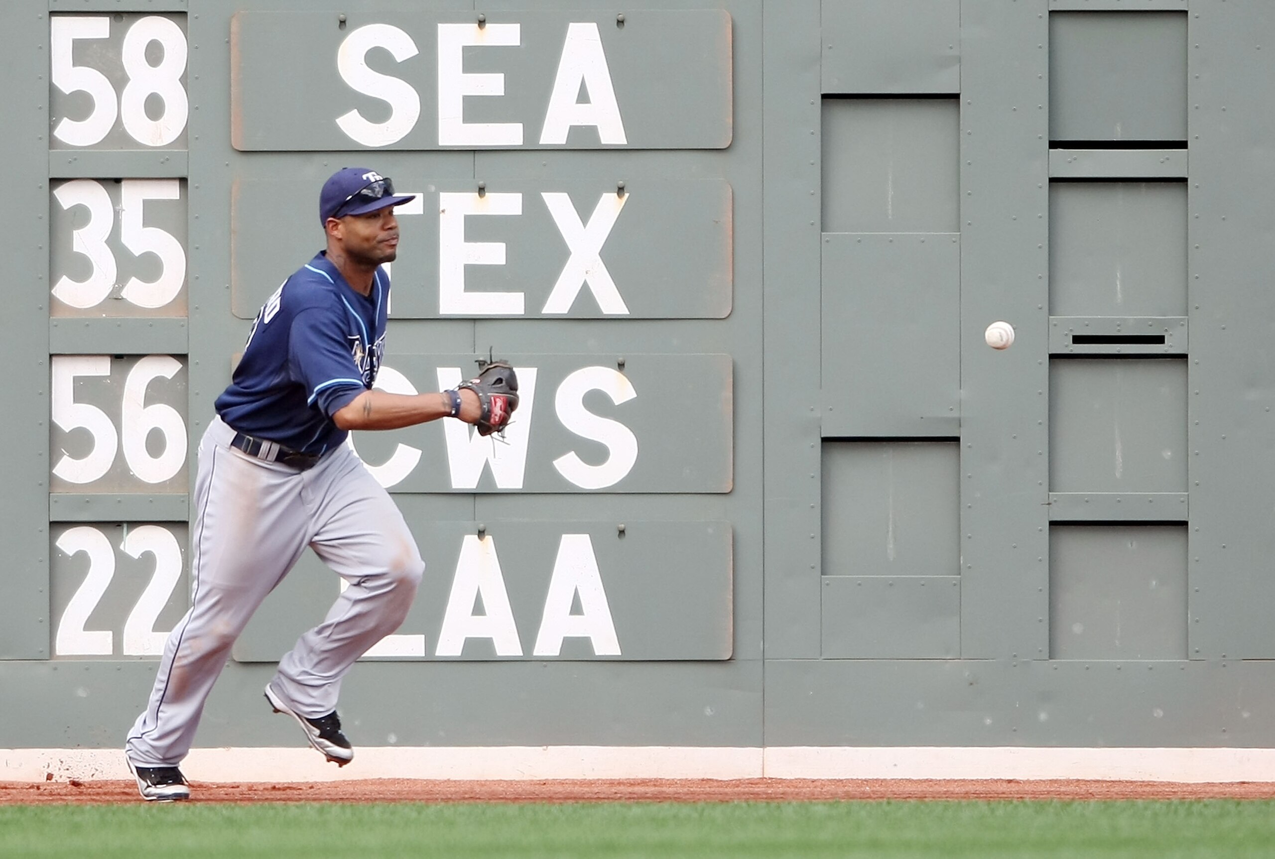 BOSTON - SEPTEMBER 13:  Carl Crawford #13 of the Tampa Bay Rays misses a hit by Victor Martinez of the Boston Red Sox on September 13, 2009 at Fenway Park in Boston, Massachusetts. The Red Sox defeated the Rays 3-1.  (Photo by Elsa/Getty Images)