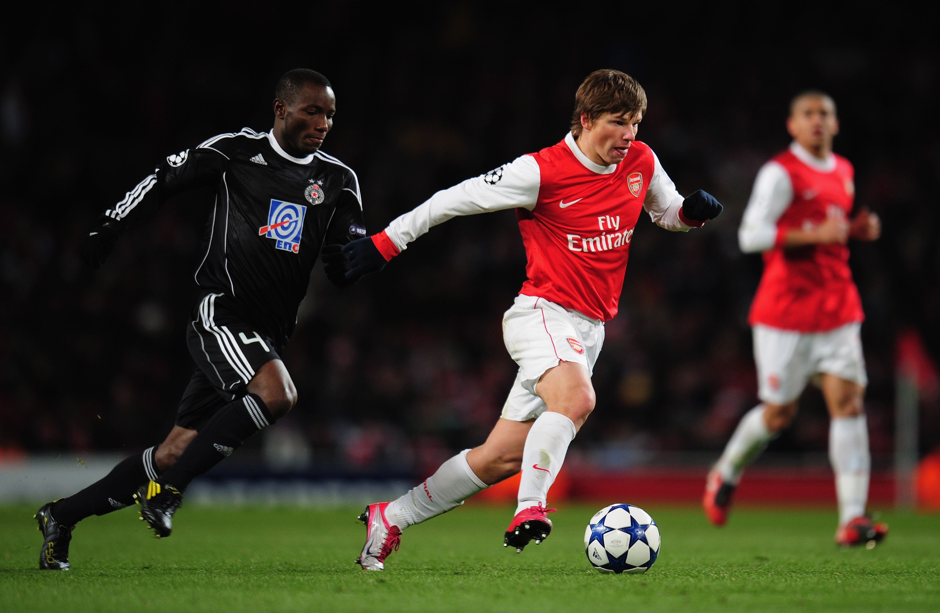 LONDON, ENGLAND - DECEMBER 08:  Mohamed Medo Kamara of FK Partizan Belgrade chases Andrey Arshavin of Arsenal during the UEFA Champions League Group H match between Arsenal and FK Partizan Belgrade at the Emirates Stadium on December 8, 2010 in London, En