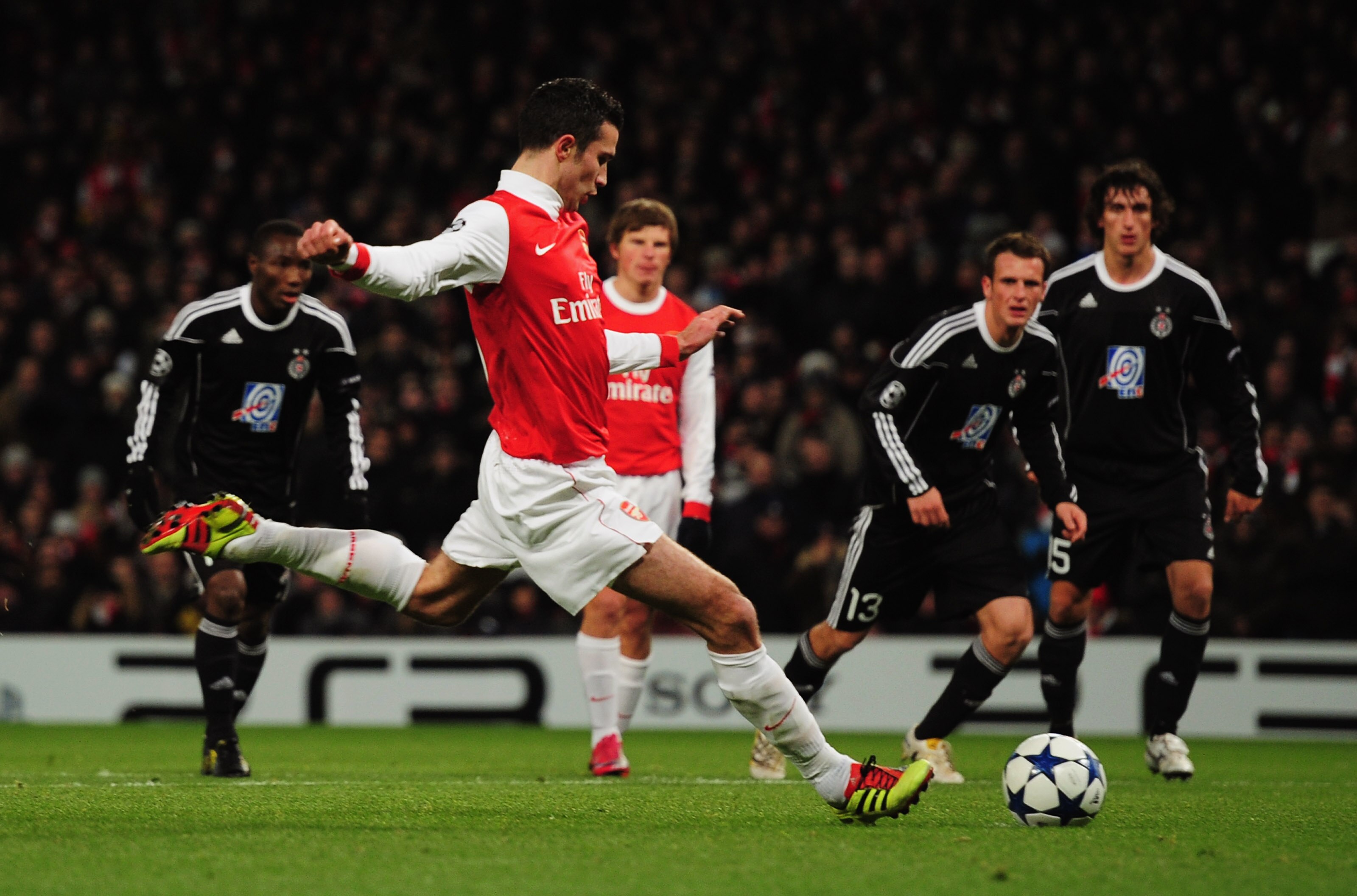 LONDON, ENGLAND - DECEMBER 08:  Robin van Persie of Arsenal scores their first goal from the penalty spot during the UEFA Champions League Group H match between Arsenal and FK Partizan Belgrade at the Emirates Stadium on December 8, 2010 in London, Englan