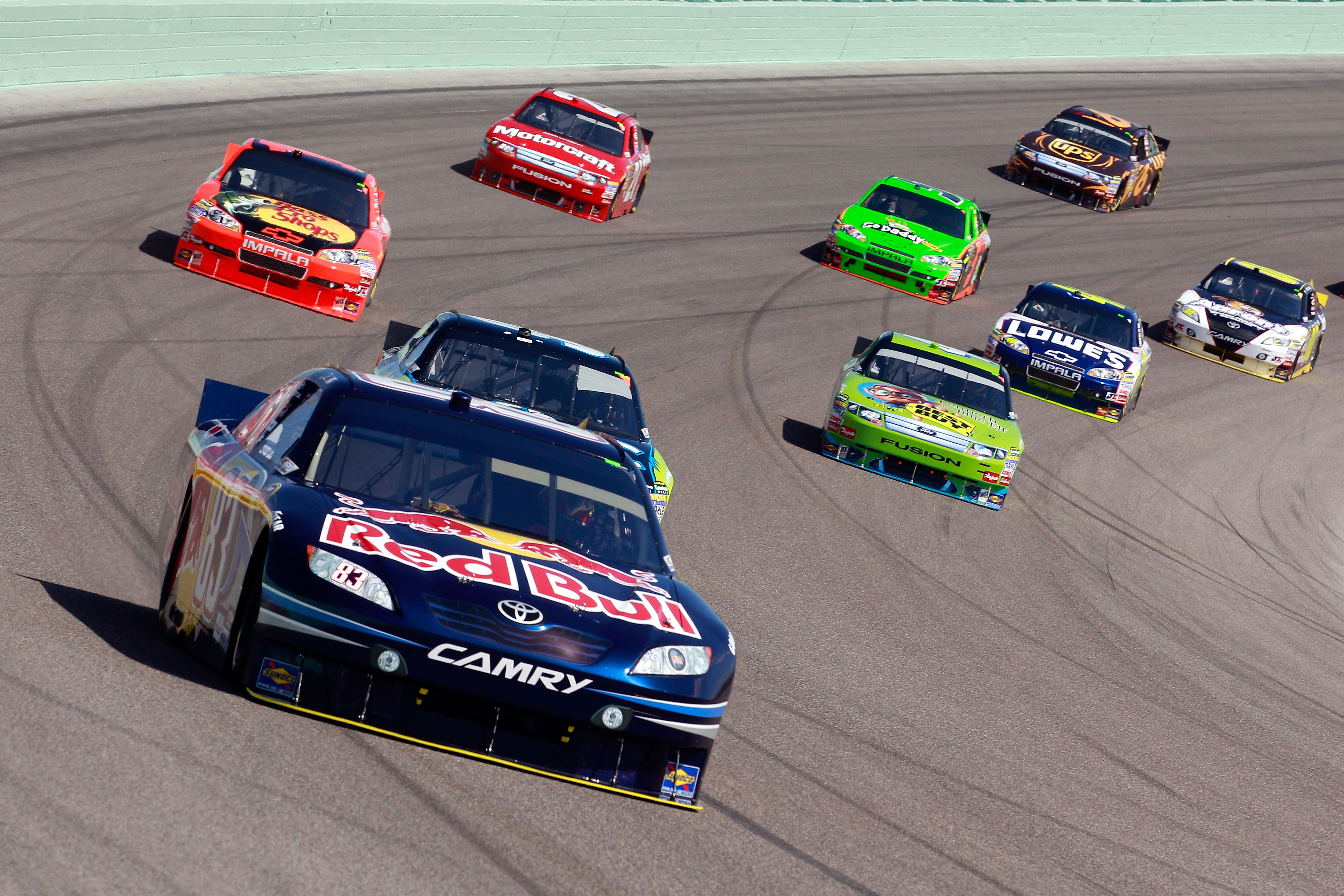 HOMESTEAD, FL - NOVEMBER 21:  Kasey Kahne, driver of the #83 Red Bull Toyota, leads a group of cars during the NASCAR Sprint Cup Series Ford 400 at Homestead-Miami Speedway on November 21, 2010 in Homestead, Florida.  (Photo by Sam Greenwood/Getty Images)