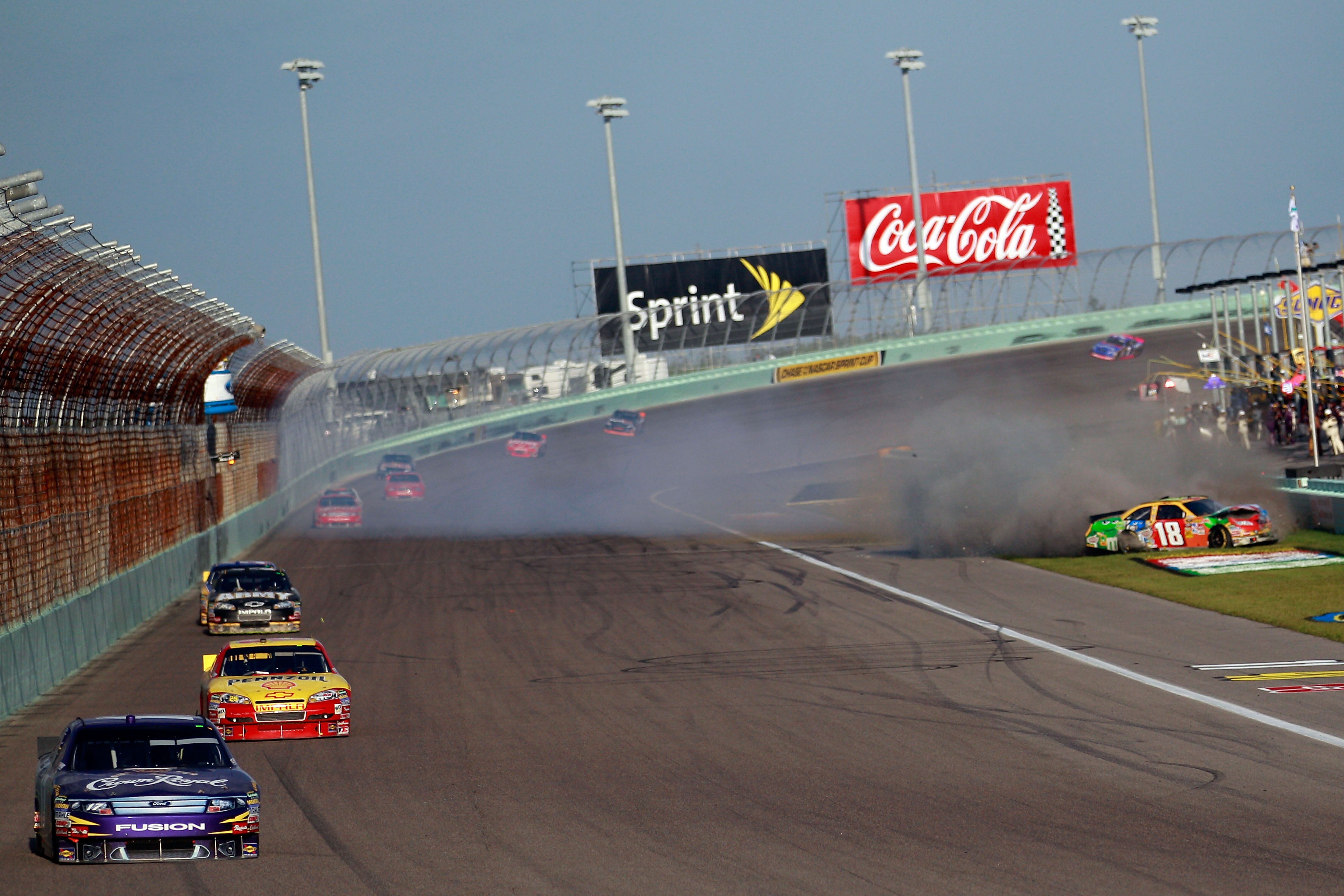 HOMESTEAD, FL - NOVEMBER 21:  Kyle Busch, driver of the #18 M&M's Toyota, crashes after being hit by Kevin Harvick, driver of the #29 Shell/Pennzoil Chevrolet, during the NASCAR Sprint Cup Series Ford 400 at Homestead-Miami Speedway on November 21, 2010 i