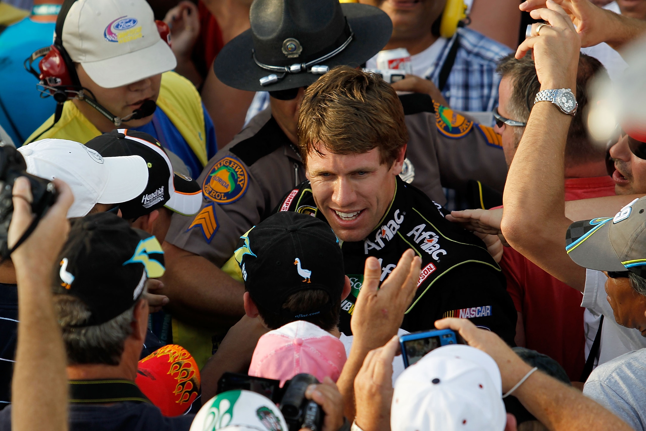HOMESTEAD, FL - NOVEMBER 21:  Carl Edwards, driver of the #99 Aflac Ford, celebrates in the stands after winning the NASCAR Sprint Cup Series Ford 400 at Homestead-Miami Speedway on November 21, 2010 in Homestead, Florida.  (Photo by Todd Warshaw/Getty Im