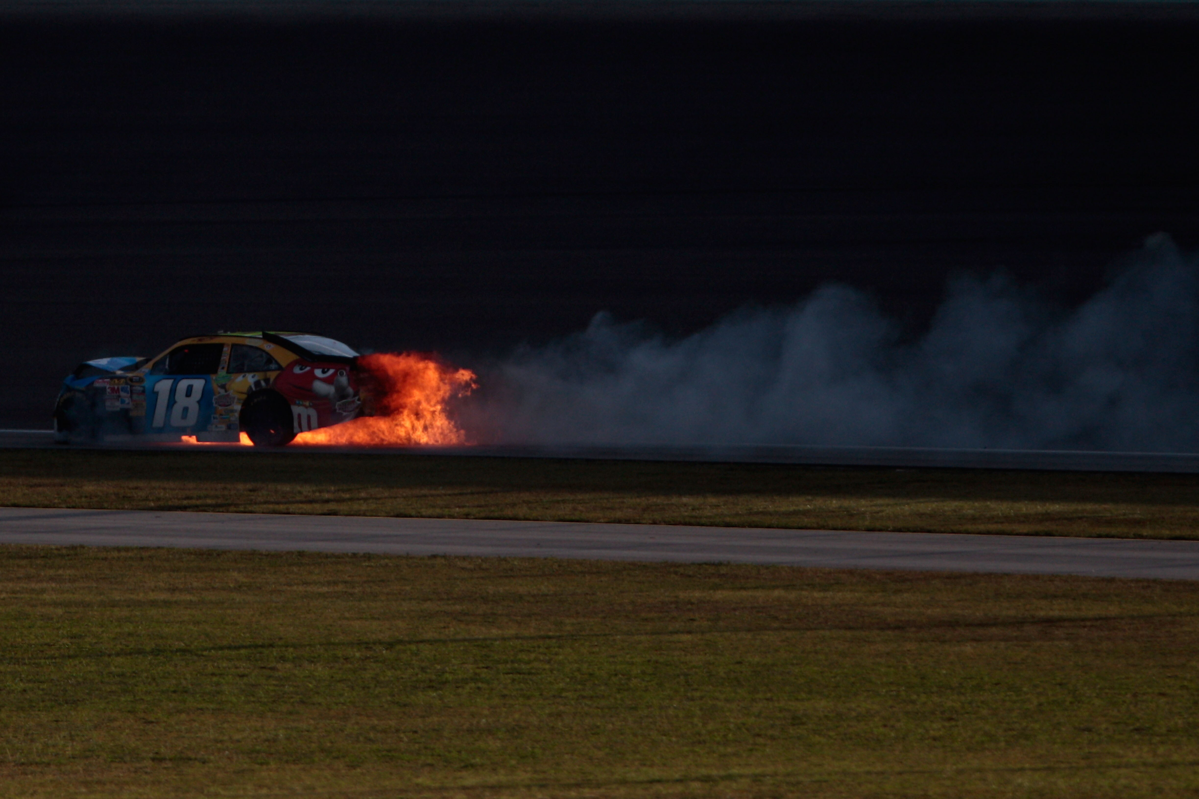HOMESTEAD, FL - NOVEMBER 21:  Kyle Busch, driver of the #18 M&M'sToyota, drives with his car on fire after crashing during the NASCAR Sprint Cup Series Ford 400 at Homestead-Miami Speedway on November 21, 2010 in Homestead, Florida.  (Photo by Chris Grayt