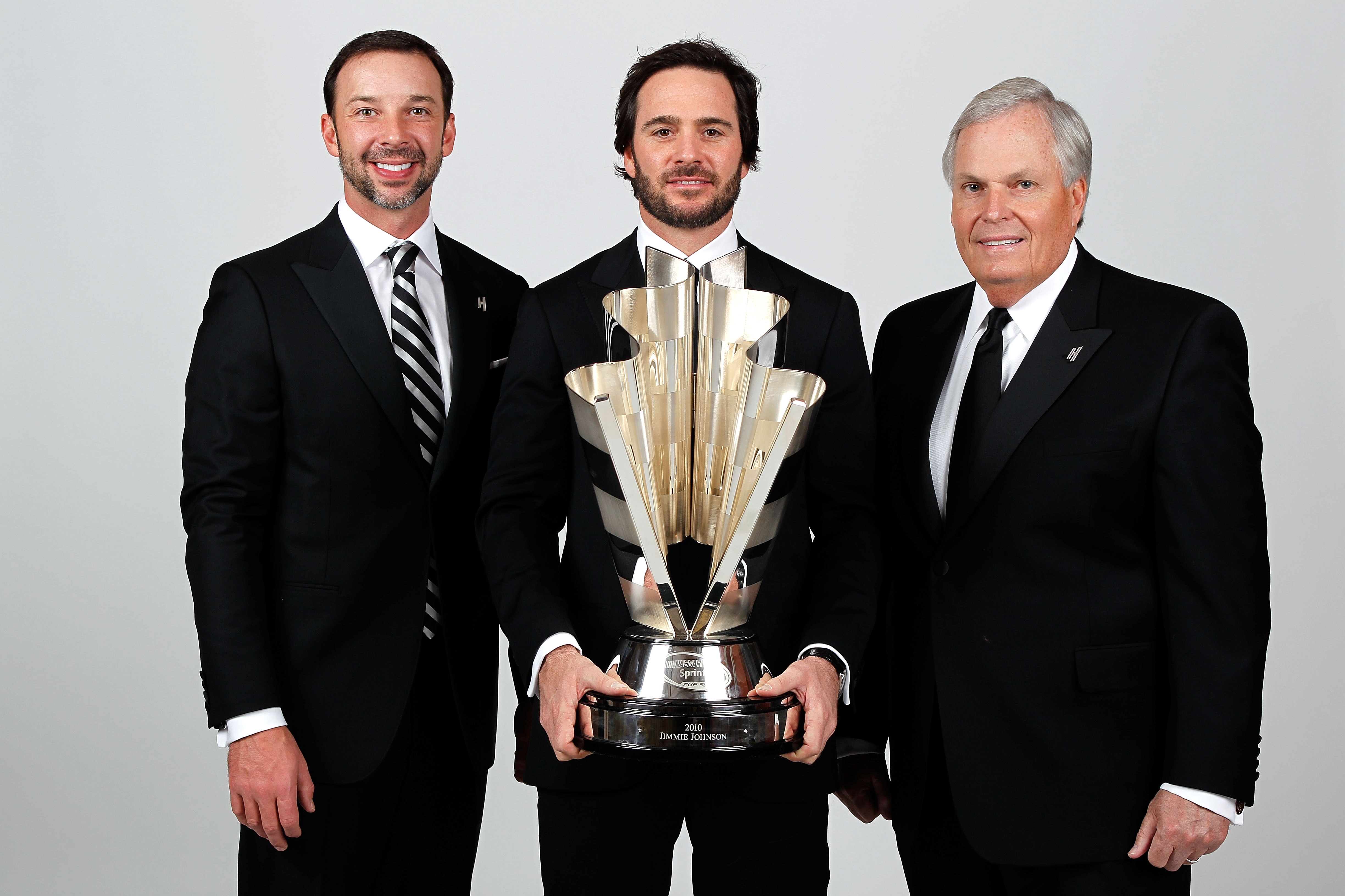 LAS VEGAS, NV - DECEMBER 03:  Five-time champion Jimmie Johnson (C) poses with team owner Rick Hendrick (R) and crew chief Chad Knaus (L) during the NASCAR Sprint Cup Series awards banquet at the Wynn Las Vegas Hotel on December 3, 2010 in Las Vegas, Neva