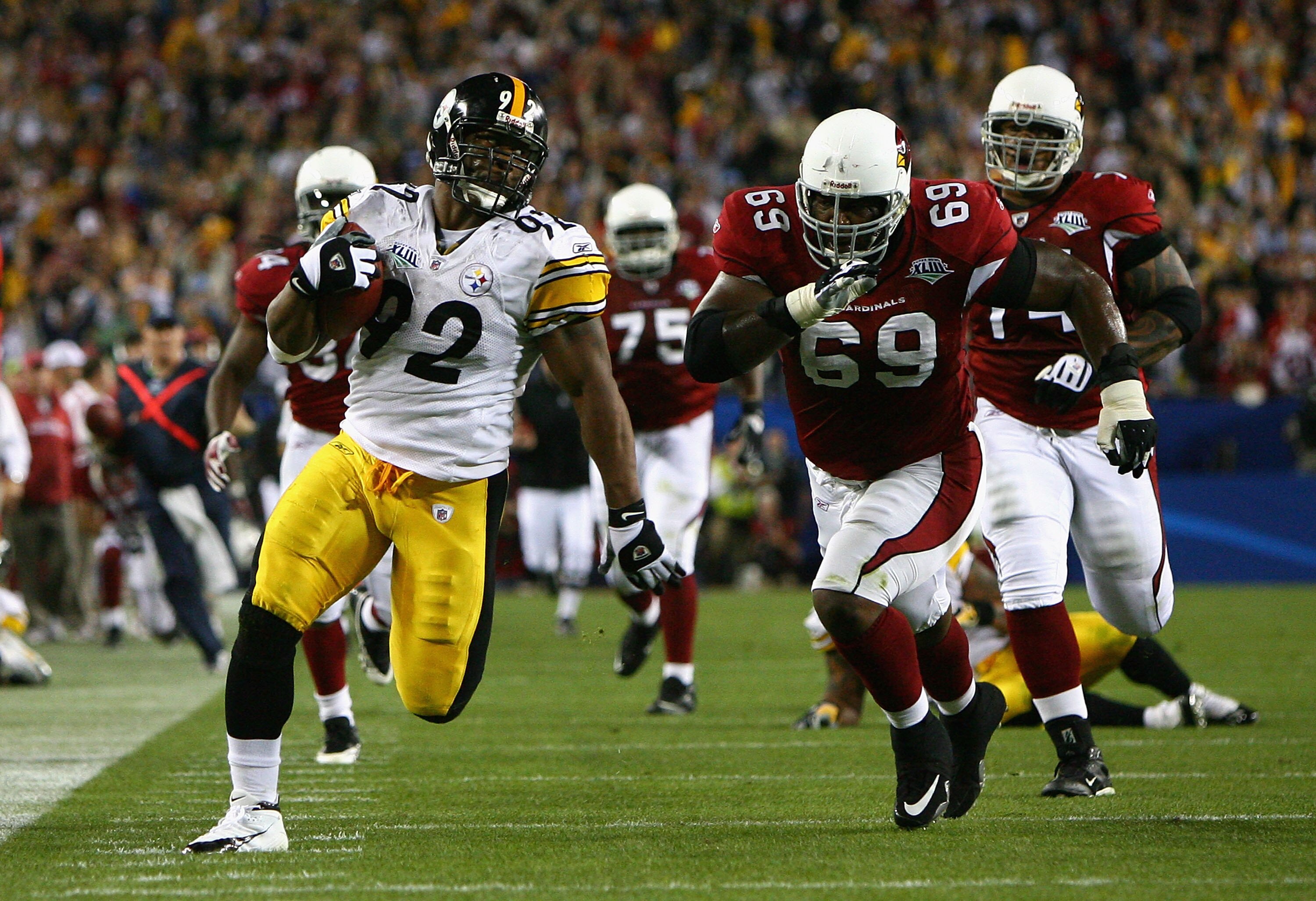 TAMPA, FL - FEBRUARY 01:  James Harrison #92 of the Pittsburgh Steelers runs back an interception for a touchdown in the second quarter against Mike Gandy #69 of the Arizona Cardinals during Super Bowl XLIII on February 1, 2009 at Raymond James Stadium in