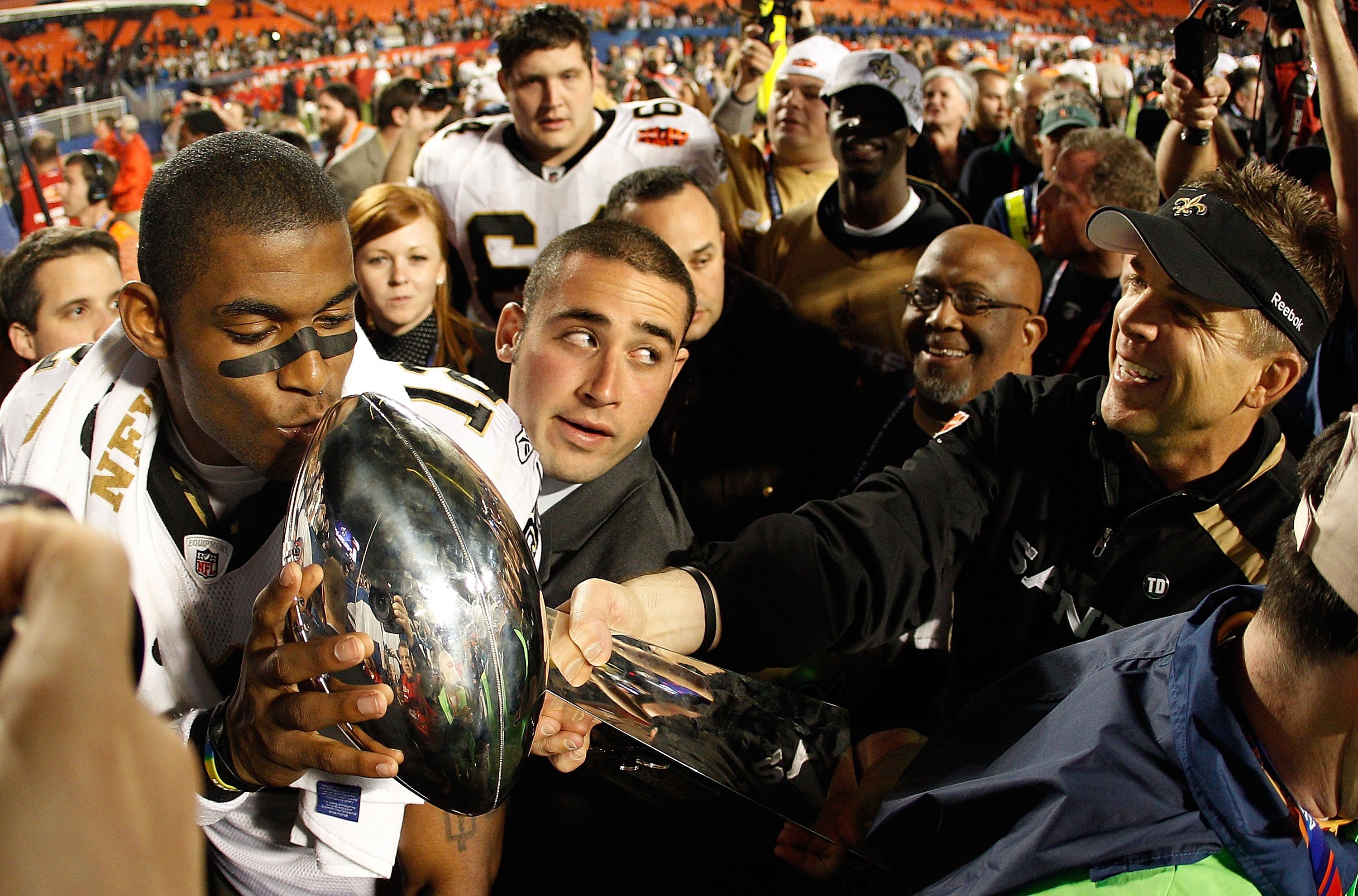 MIAMI GARDENS, FL - FEBRUARY 07:  Head coach Sean Payton of the New Orleans Saints reaches out to have Marques Colston #12 kiss the Vince Lombardi Trophy after defeating the Indianapolis Colts during Super Bowl XLIV on February 7, 2010 at Sun Life Stadium