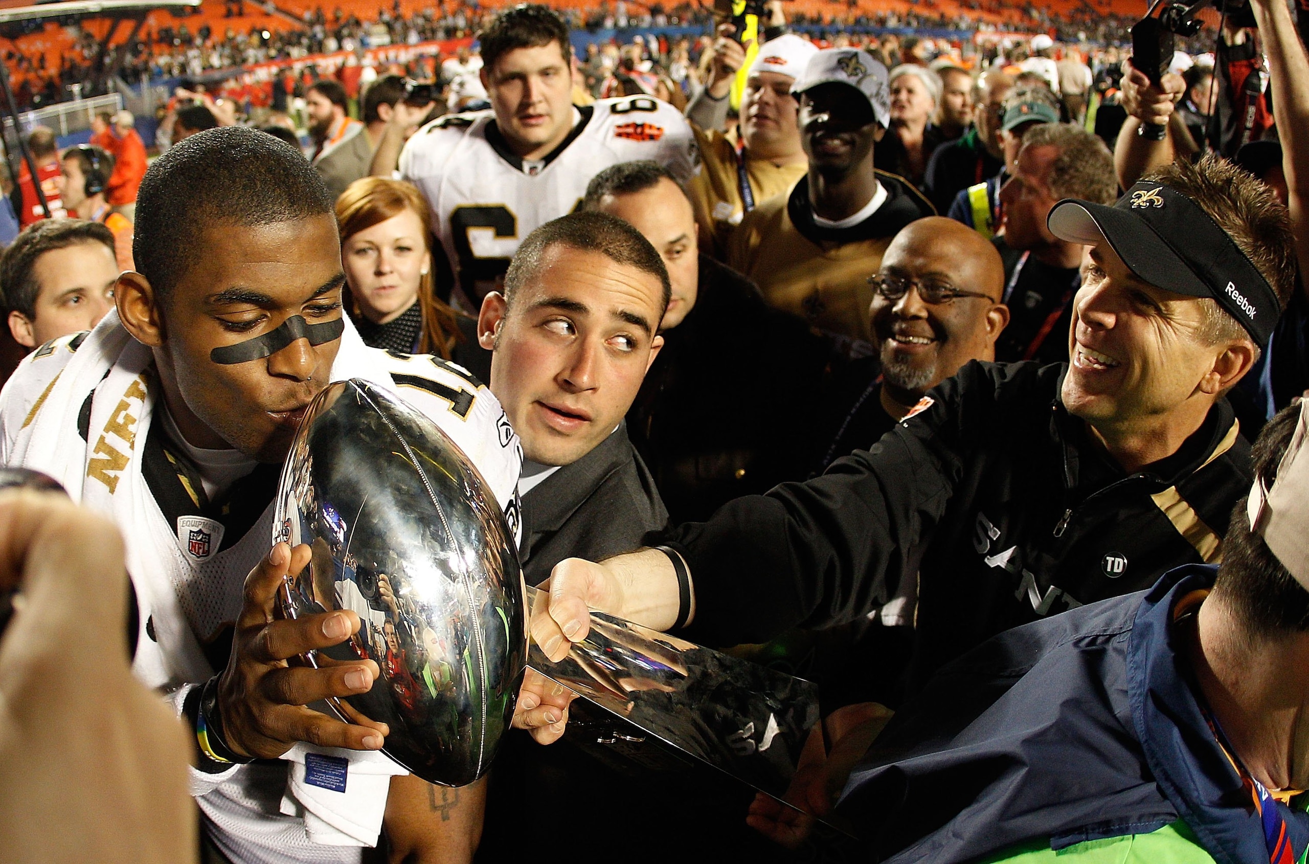 MIAMI GARDENS, FL - FEBRUARY 07:  Head coach Sean Payton of the New Orleans Saints reaches out to have Marques Colston #12 kiss the Vince Lombardi Trophy after defeating the Indianapolis Colts during Super Bowl XLIV on February 7, 2010 at Sun Life Stadium