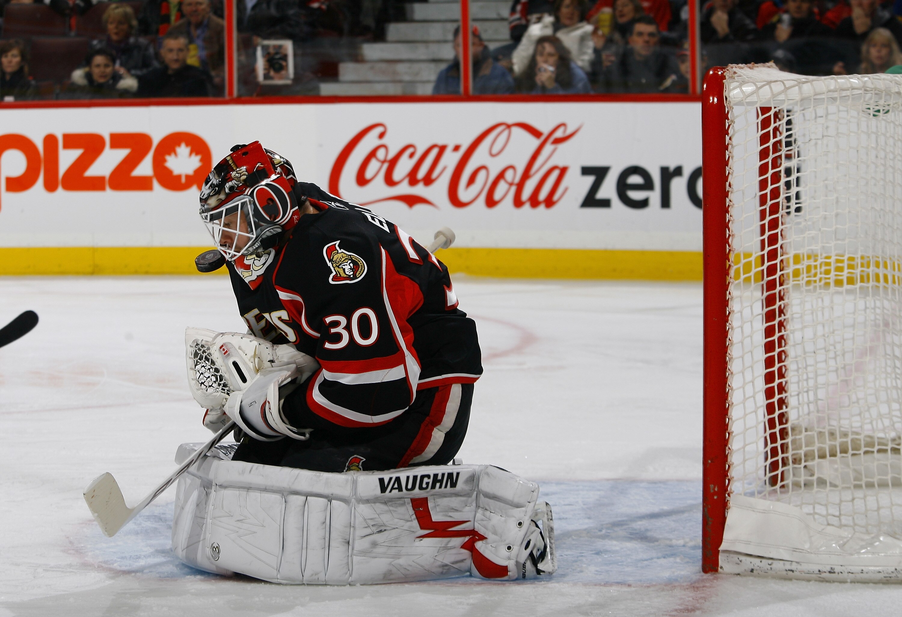 OTTAWA, ON - DECEMBER 04:  Brian Elliott #30 of the Ottawa Senators keeps his eyes on the puck after a rebound in a game against the Buffalo Sabres at Scotiabank Place on December 4, 2010 in Ottawa, Ontario, Canada.  (Photo by Phillip MacCallum/Getty Imag