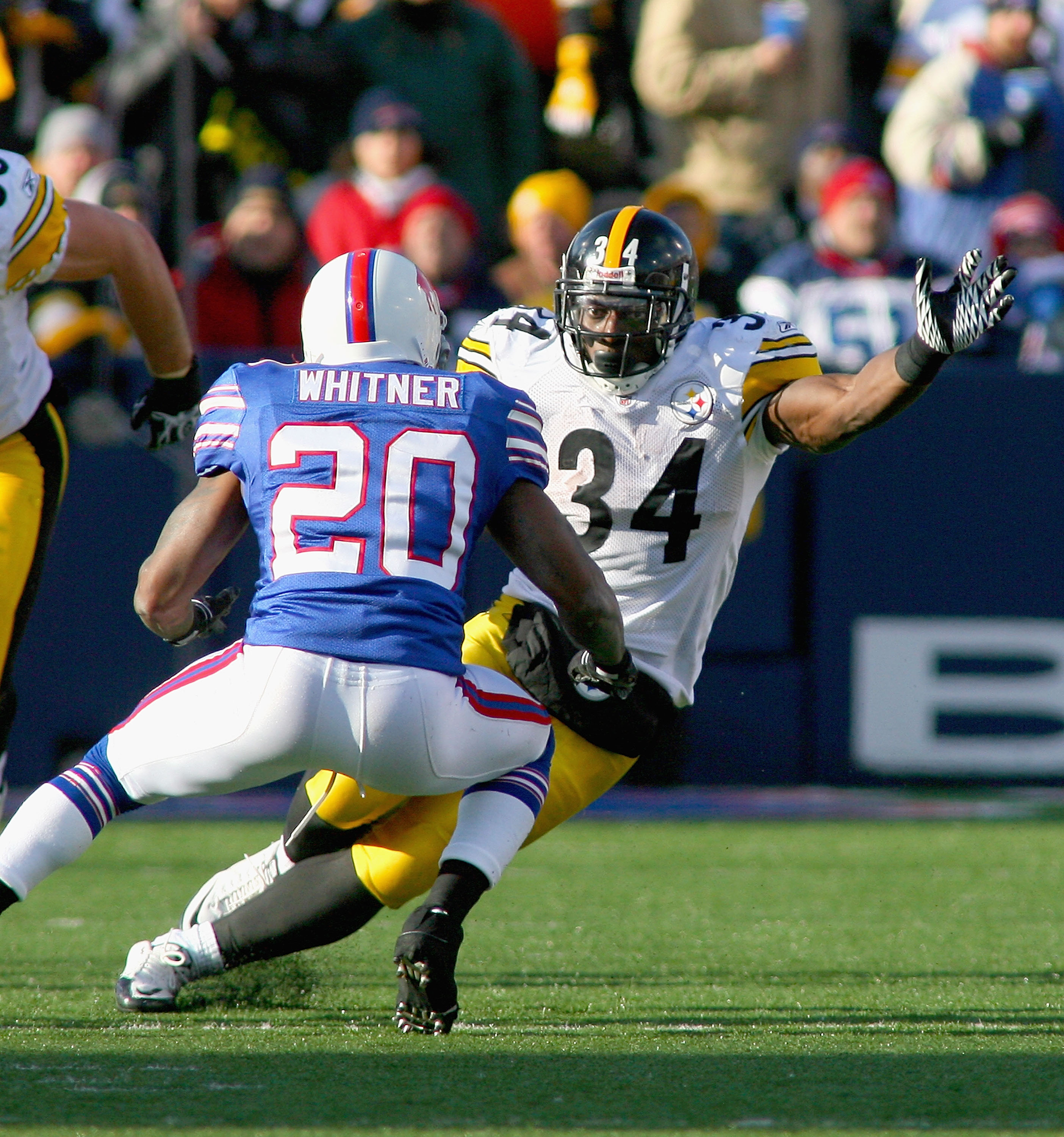 ORCHARD PARK, NY - NOVEMBER 28: Rashard Mendenhall #34  of the Pittsburgh Steelers runs against Donte Whitner #20 of the Buffalo Bills  at Ralph Wilson Stadium at Ralph Wilson Stadium on November 28, 2010 in Orchard Park, New York.  (Photo by Rick Stewart
