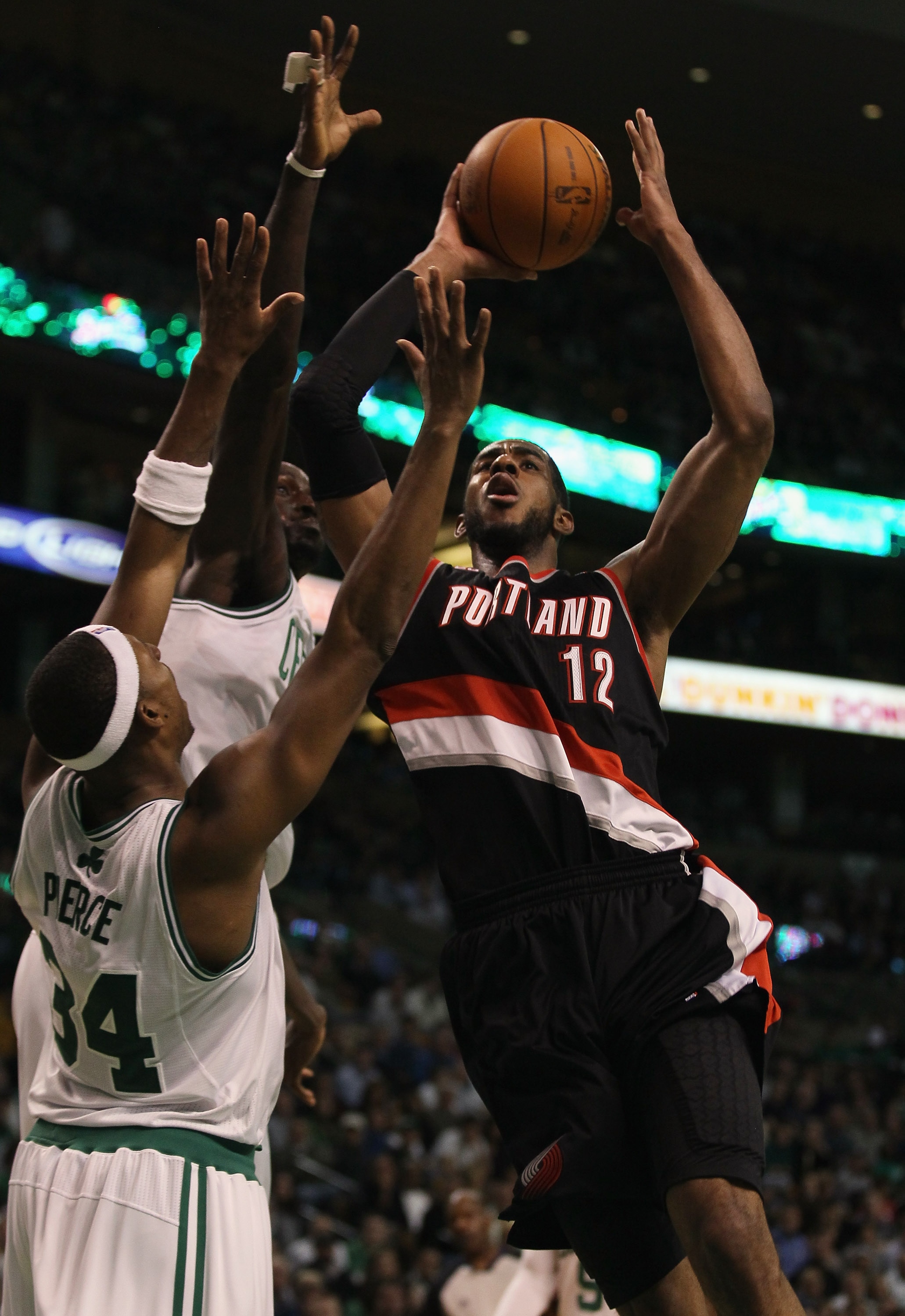BOSTON - DECEMBER 01:  LaMarcus Aldridge #12 of the Portland Trailblazers tries to shoot around Paul Pierce #34 and Kevin Garnett #5 of the Boston Celtics on December 1, 2010 at the TD Garden in Boston, Massachusetts. The Celtics defeated the Trailblazers