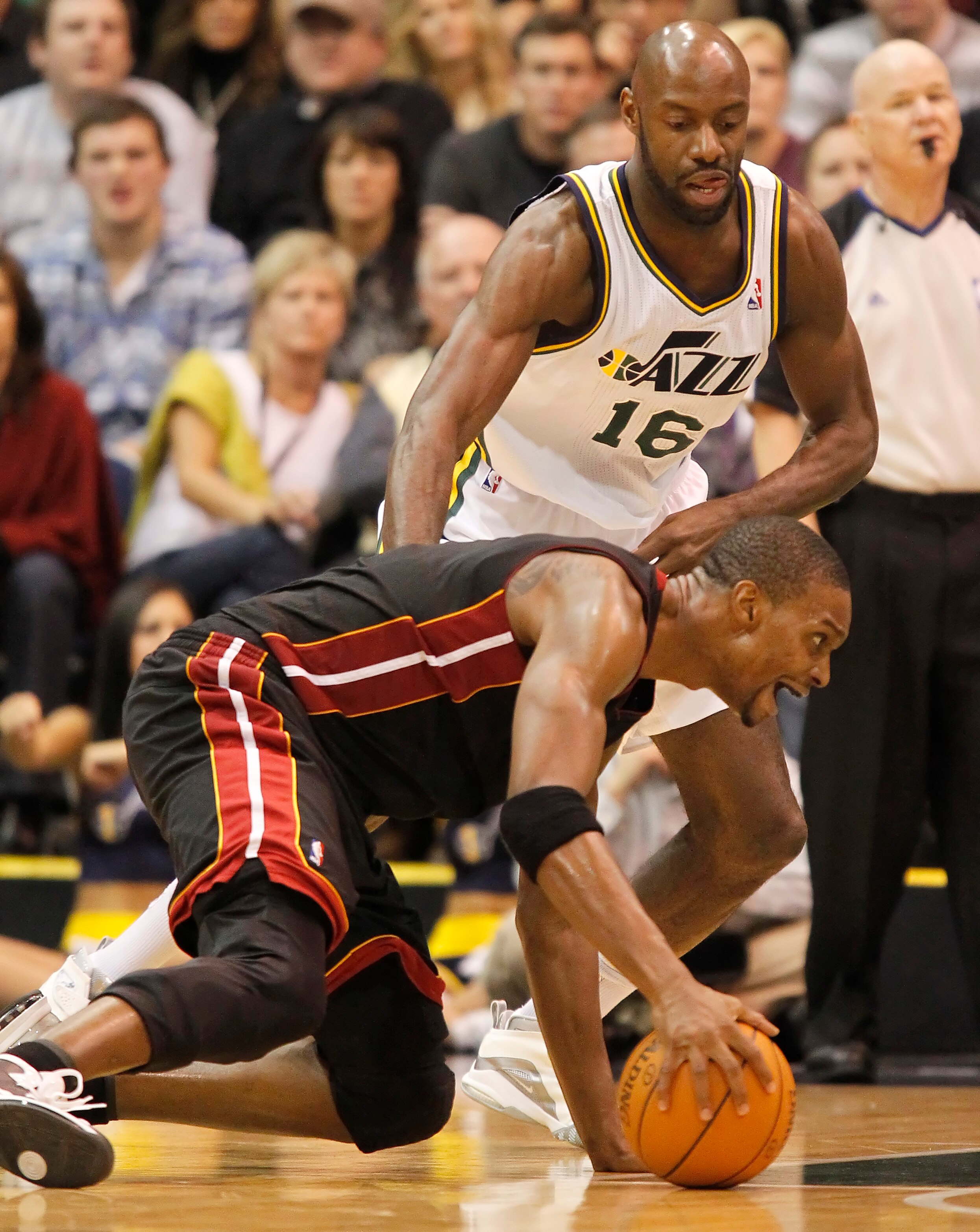 SALT LAKE CITY, UT - DECEMBER 8: Chris Bosh #1 of the Miami Heat falls to the ground as Francisco Elson #16 of the Utah Jazz during the second half of an NBA game December 8, 2010 at Energy Solutions Arena in Salt Lake City, Utah. The Heat beat the Jazz 1