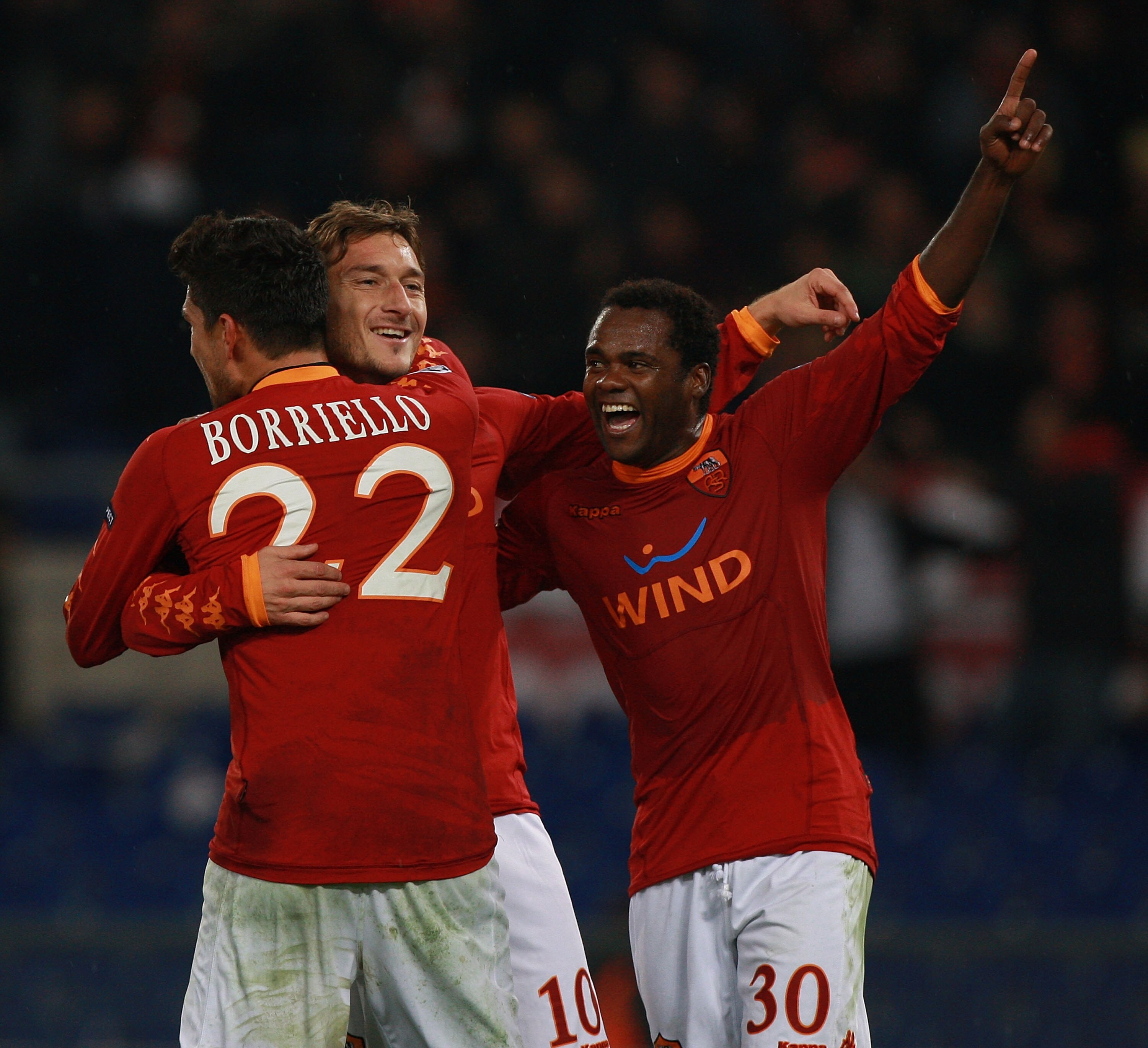 ROME - NOVEMBER 23:  Francesco Totti (C) with his teammates Marco Borriello #22 and Fabio Simplicio (R) of AS Roma celebrates after scoring the third goal during the UEFA Champions League Group E match between AS Roma and FC Bayern Muenchen at Stadio Olim
