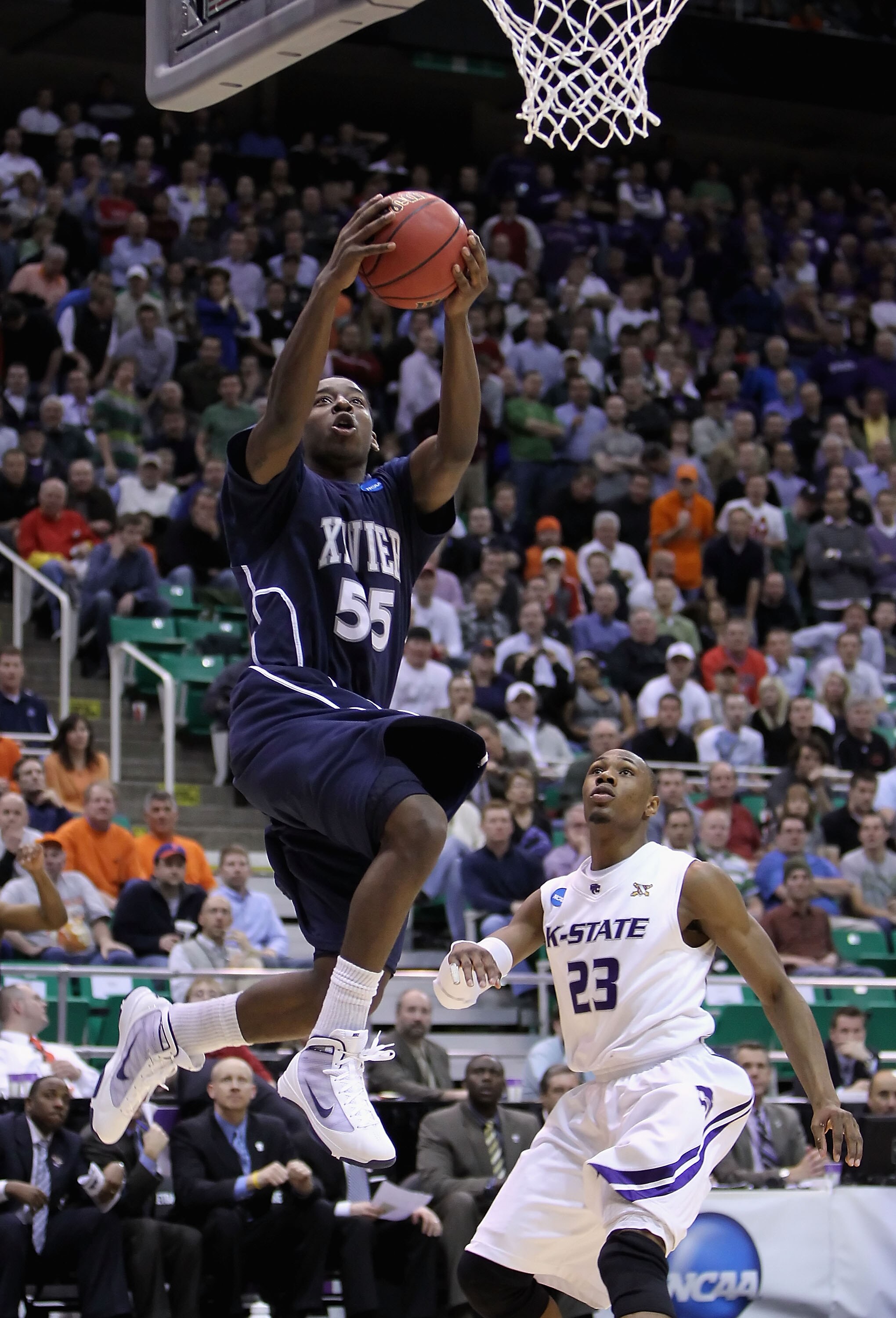 SALT LAKE CITY - MARCH 25:  Jordan Crawford #55 of the Xavier Musketeers lays up a shot past Dominique Sutton #23 of the Kansas State Wildcats during the west regional semifinal of the 2010 NCAA men's basketball tournament at the Energy Solutions Arena on