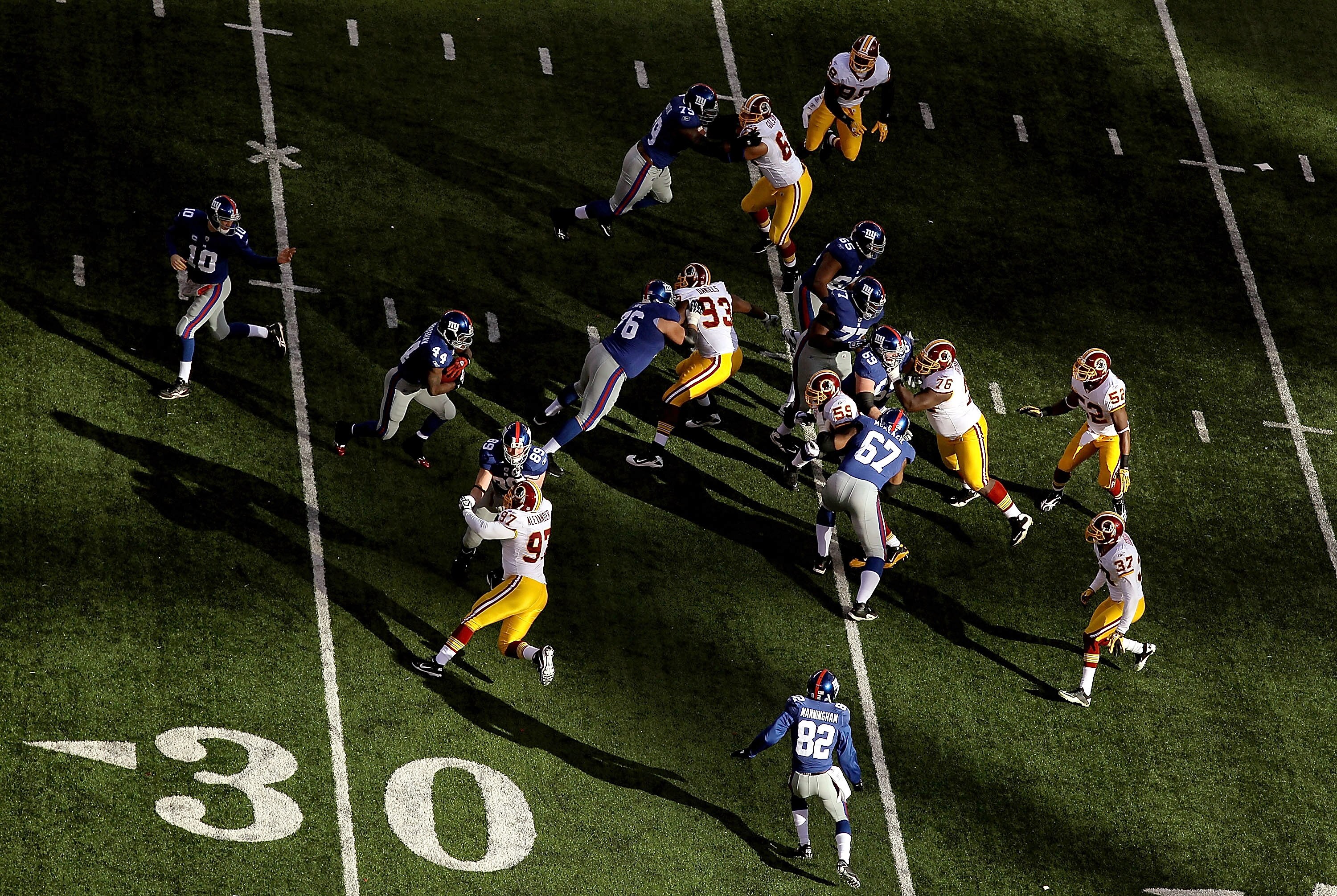 EAST RUTHERFORD, NJ - DECEMBER 05:  Eli Manning #10 hands the ball off to Ahmad Bradshaw #44 of the New York Giants during a game against the Washington Redskins during their game on December 5, 2010 at The New Meadowlands Stadium in East Rutherford, New