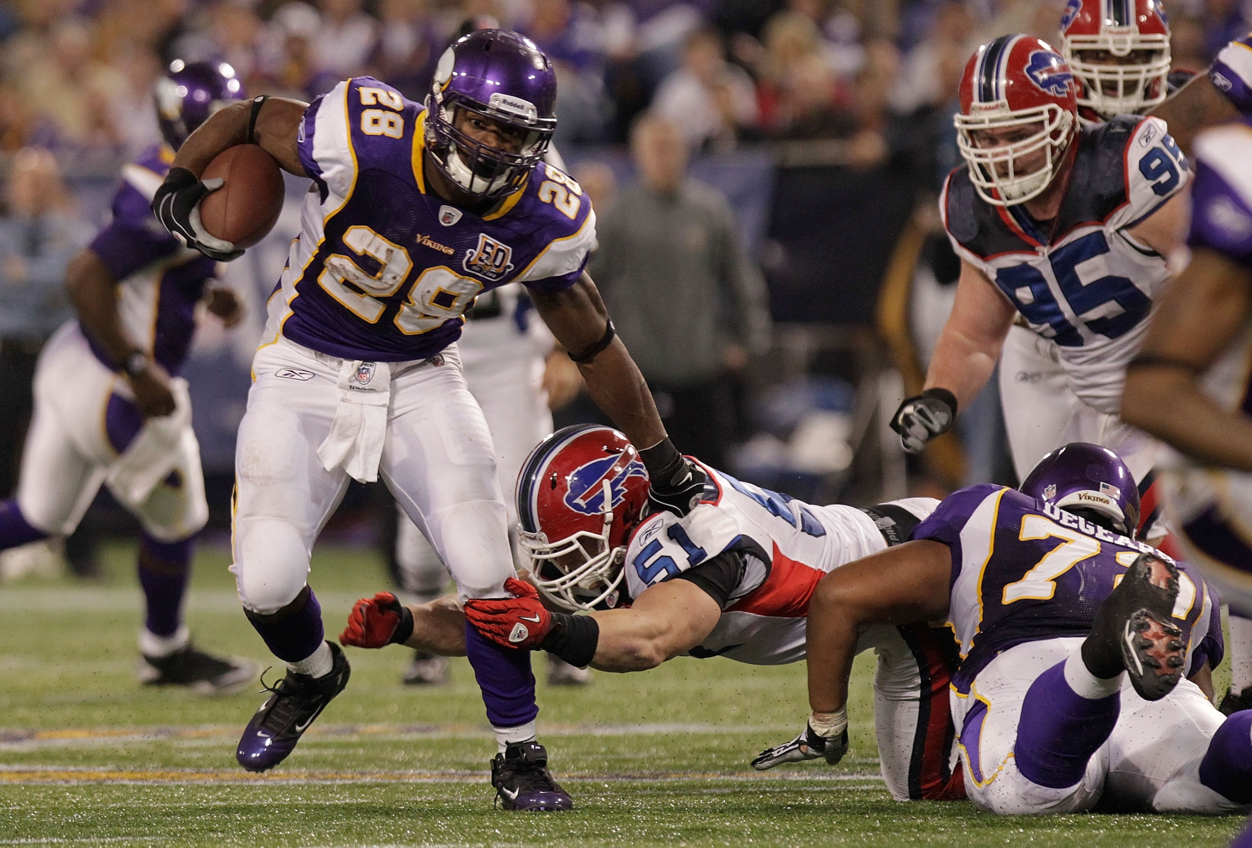MINNEAPOLIS, MN - DECEMBER 05:  Adrian Peterson #28 of the Minnesota Vikings rushes against  the Buffalo Bills at the Mall of America Field at the Hubert H. Humphrey Metrodome on December 5, 2010 in Minneapolis, Minnesota.  (Photo by Nick Laham/Getty Imag