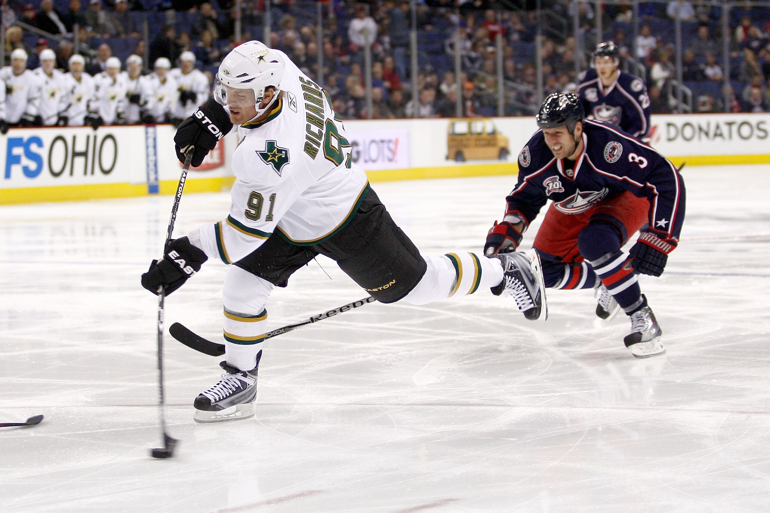 COLUMBUS, OH - DECEMBER 6:  Marc Methot #3 of the Columbus Blue Jackets chases as Brad Richards #91 of the Dallas Stars fires a the puck during the first period on December 6, 2010 at Nationwide Arena in Columbus, Ohio.  (Photo by John Grieshop/Getty Imag