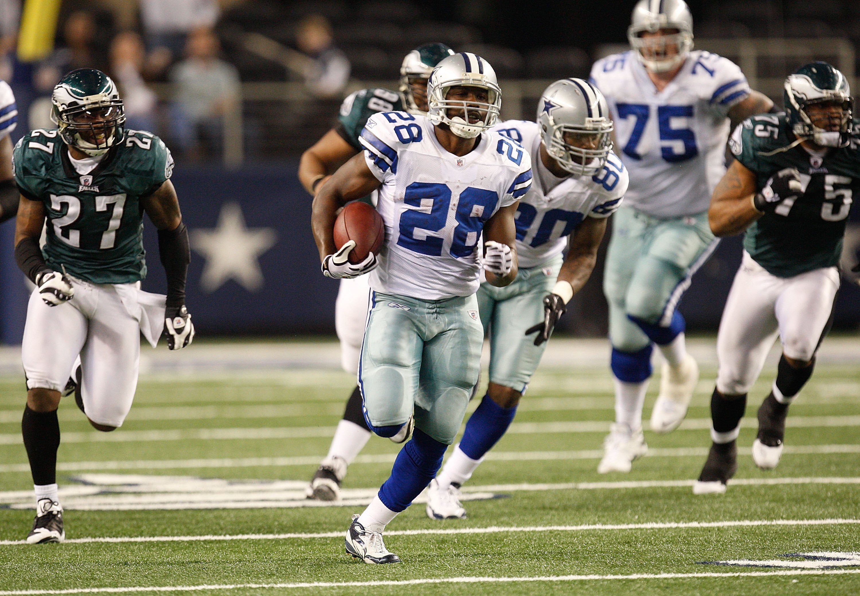 ARLINGTON, TX - JANUARY 09:  Running back Felix Jones #28 of the Dallas Cowboys runs the ball against the Philadelphia Eagles during the 2010 NFC wild-card playoff game at Cowboys Stadium on January 9, 2010 in Arlington, Texas.  (Photo by Ronald Martinez/