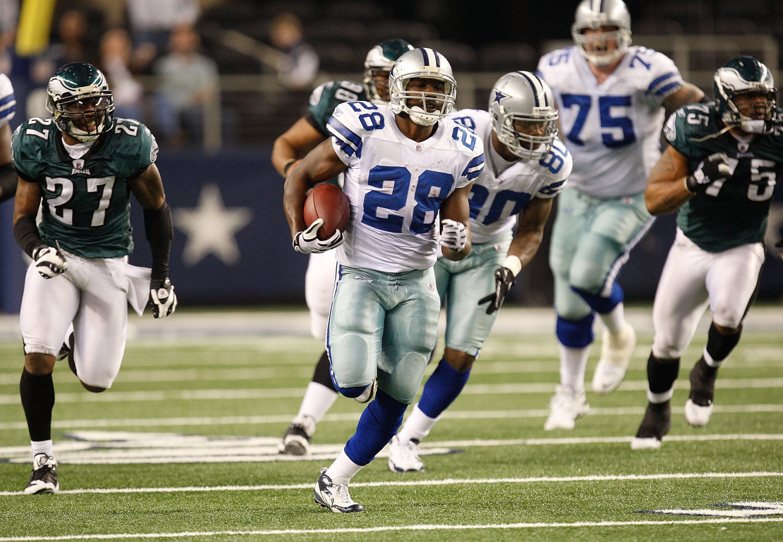 ARLINGTON, TX - JANUARY 09:  Running back Felix Jones #28 of the Dallas Cowboys runs the ball against the Philadelphia Eagles during the 2010 NFC wild-card playoff game at Cowboys Stadium on January 9, 2010 in Arlington, Texas.  (Photo by Ronald Martinez/