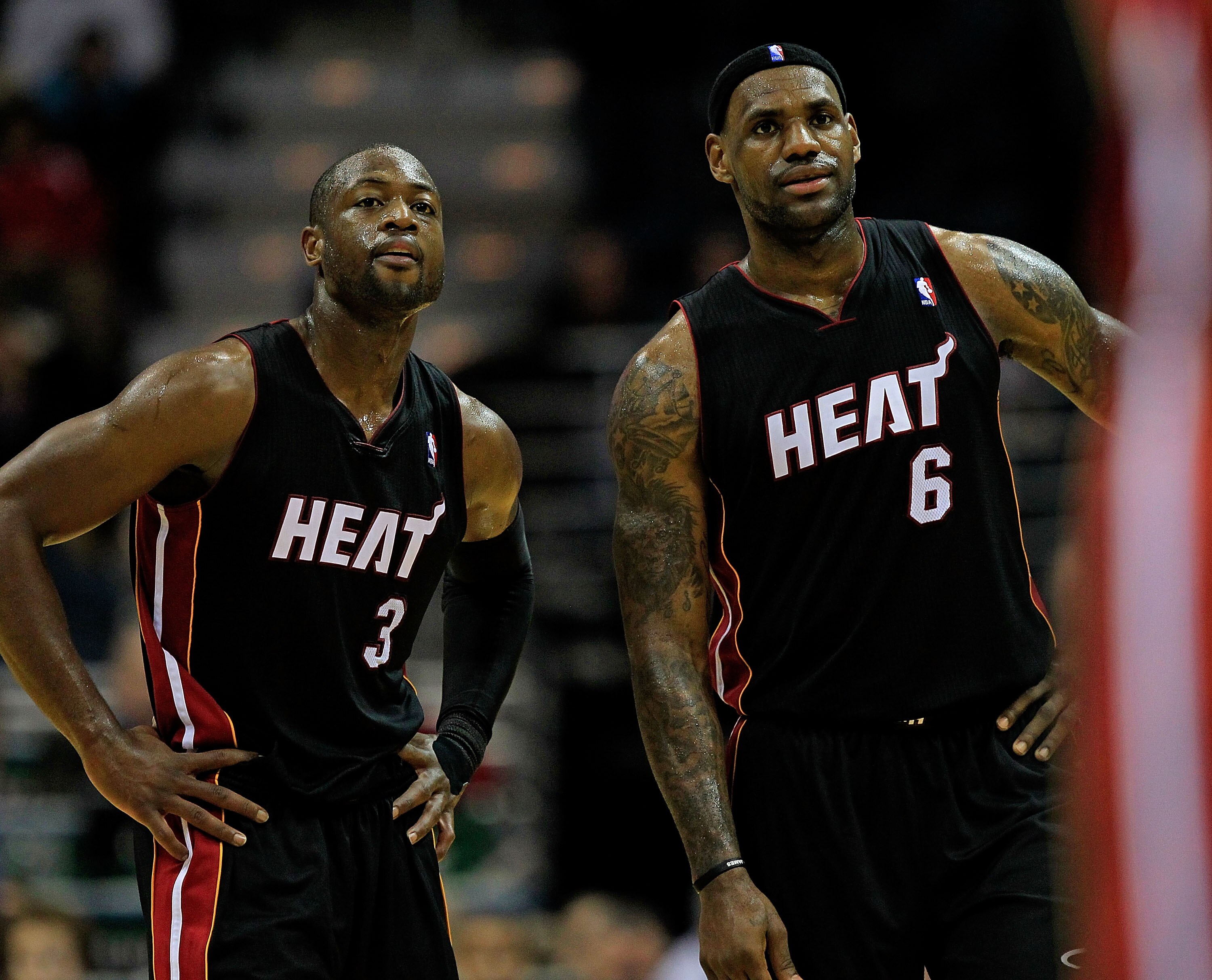 MILWAUKEE, WI - DECEMBER 06: (L-R) Dwyane Wade #3 and LeBron James #6 of the Miami Heat watch as a teammate readies to shoot a free-throw against the Milwaukee Bucks at the Bradley Center on December 6, 2010 in Milwaukee, Wisconsin. The Heat defeated the