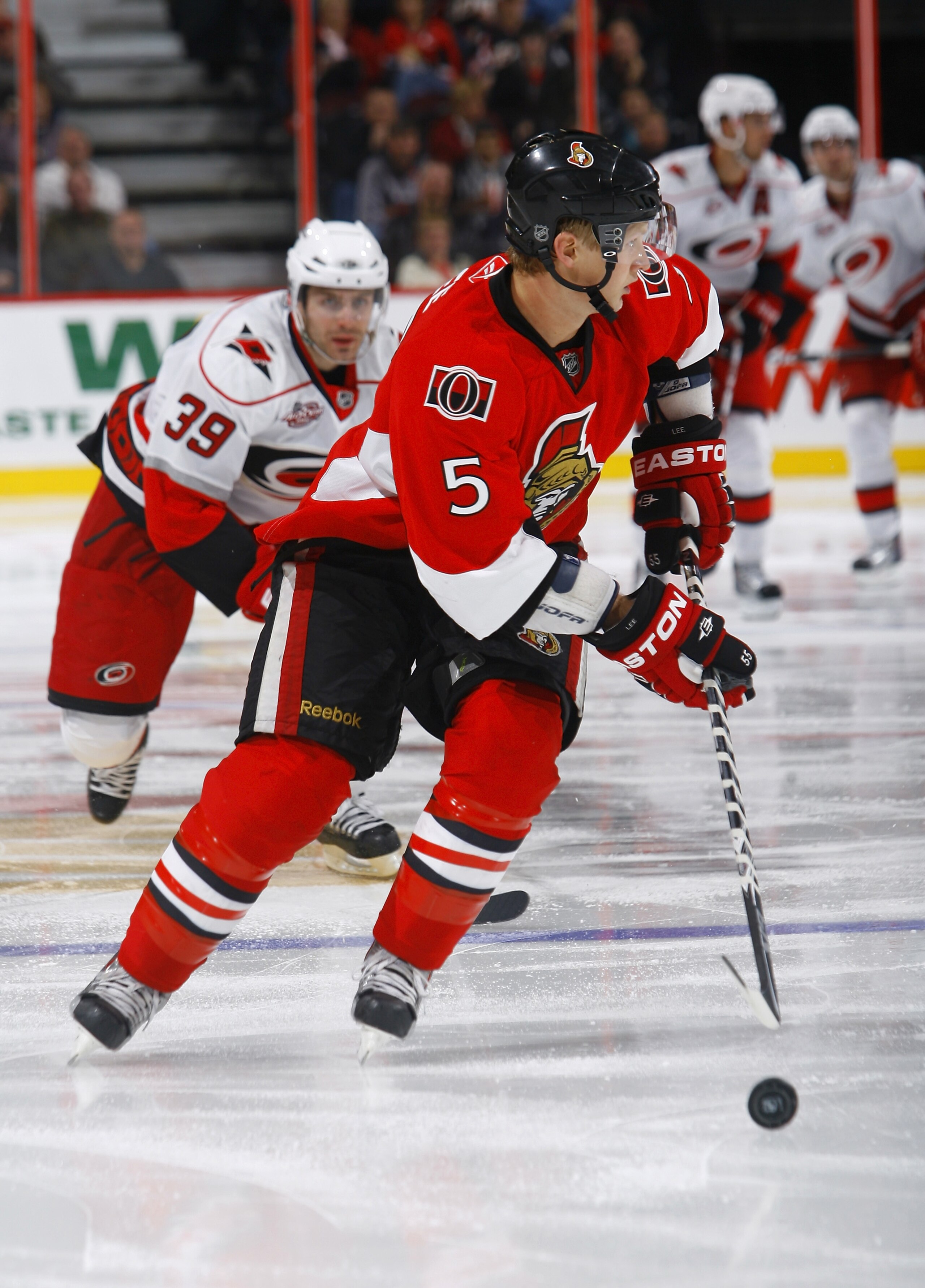 OTTAWA, ON - OCTOBER 14:  Brian Lee #5 of the Ottawa Senators chases after a loose puck during a game against the Carolina Hurricanes at Scotiabank Place on October 14, 2010 in Ottawa, Ontario, Canada.  The Ottawa Senators defeated the Carolina Hurricanes