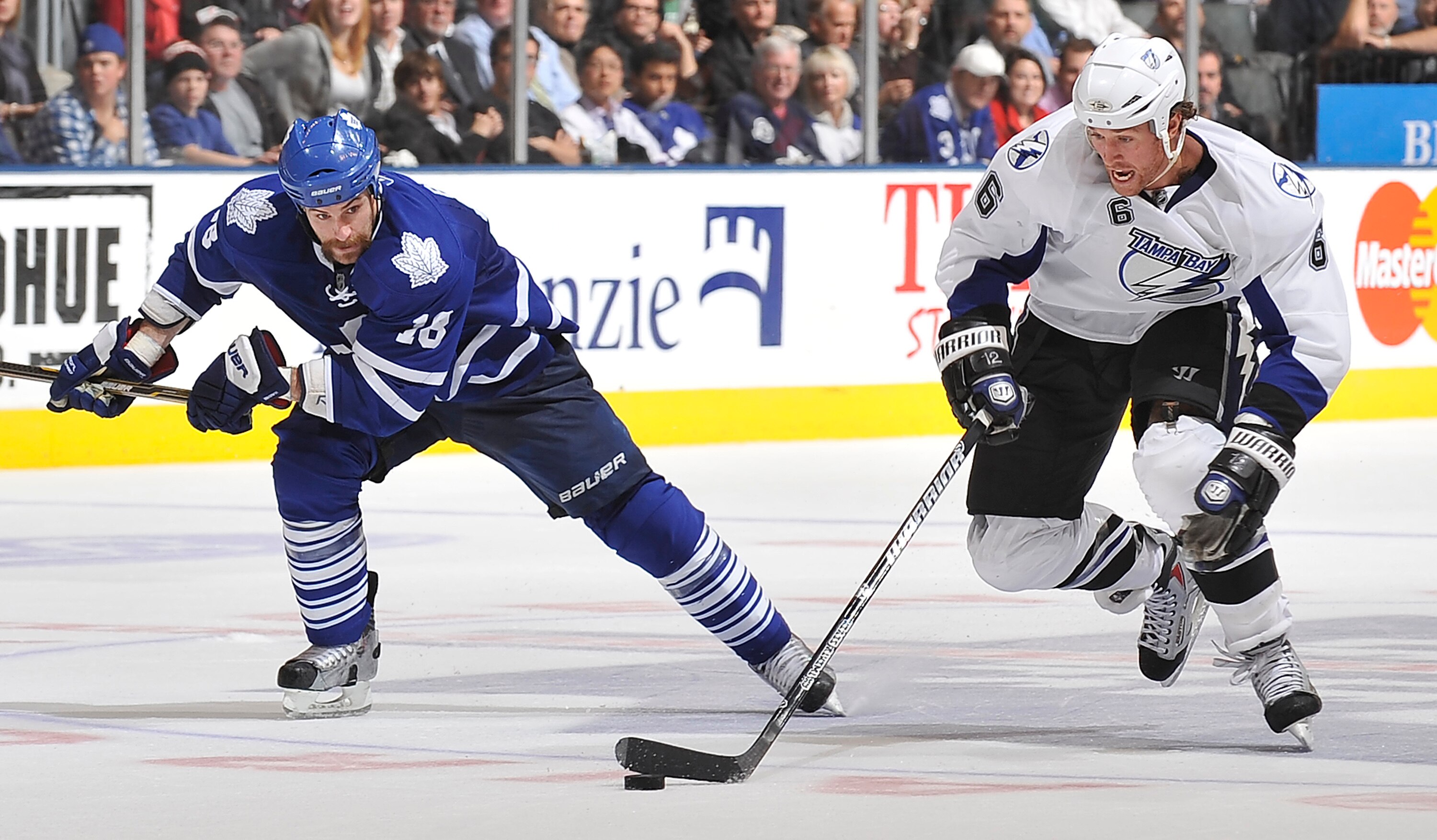 TORONTO, CANADA - NOVEMBER 30:  Mike Brown #18 of the Toronto Maple Leafs skates after Ryan Malone #6 of the Tampa Bay Lightning during game action November 30, 2010 at the Air Canada Centre in Toronto, Ontario, Canada. (Photo by Abelimages/Getty Images)
