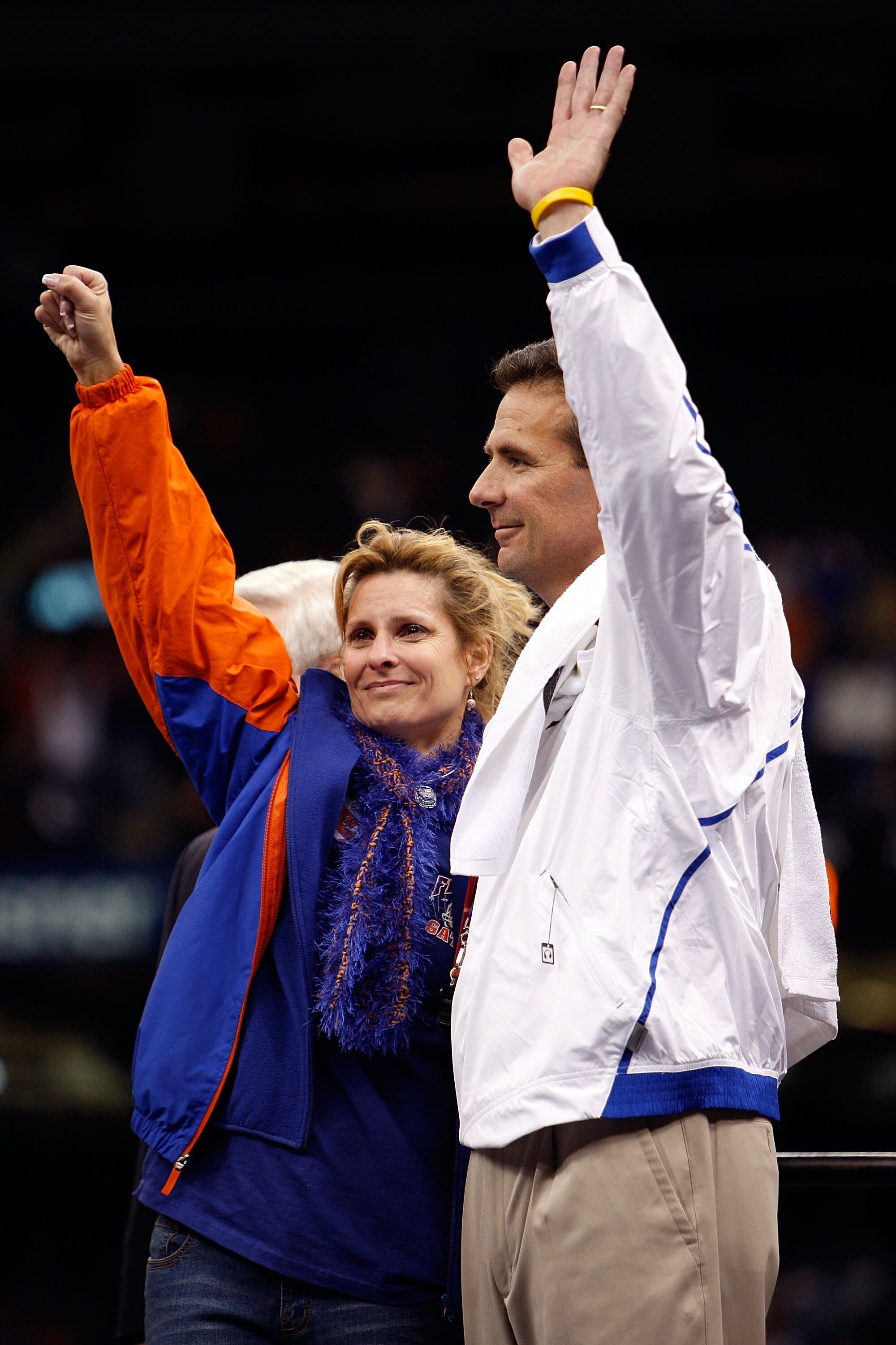 NEW ORLEANS - JANUARY 01:  Head coach Urban Meyer (R) of the Florida Gators waves to the crowd with his wife Shelley Mather Meyer on the field after the Gators defeated the Cincinnati Bearcats 24-51 in the Allstate Sugar Bowl at the Louisana Superdome on