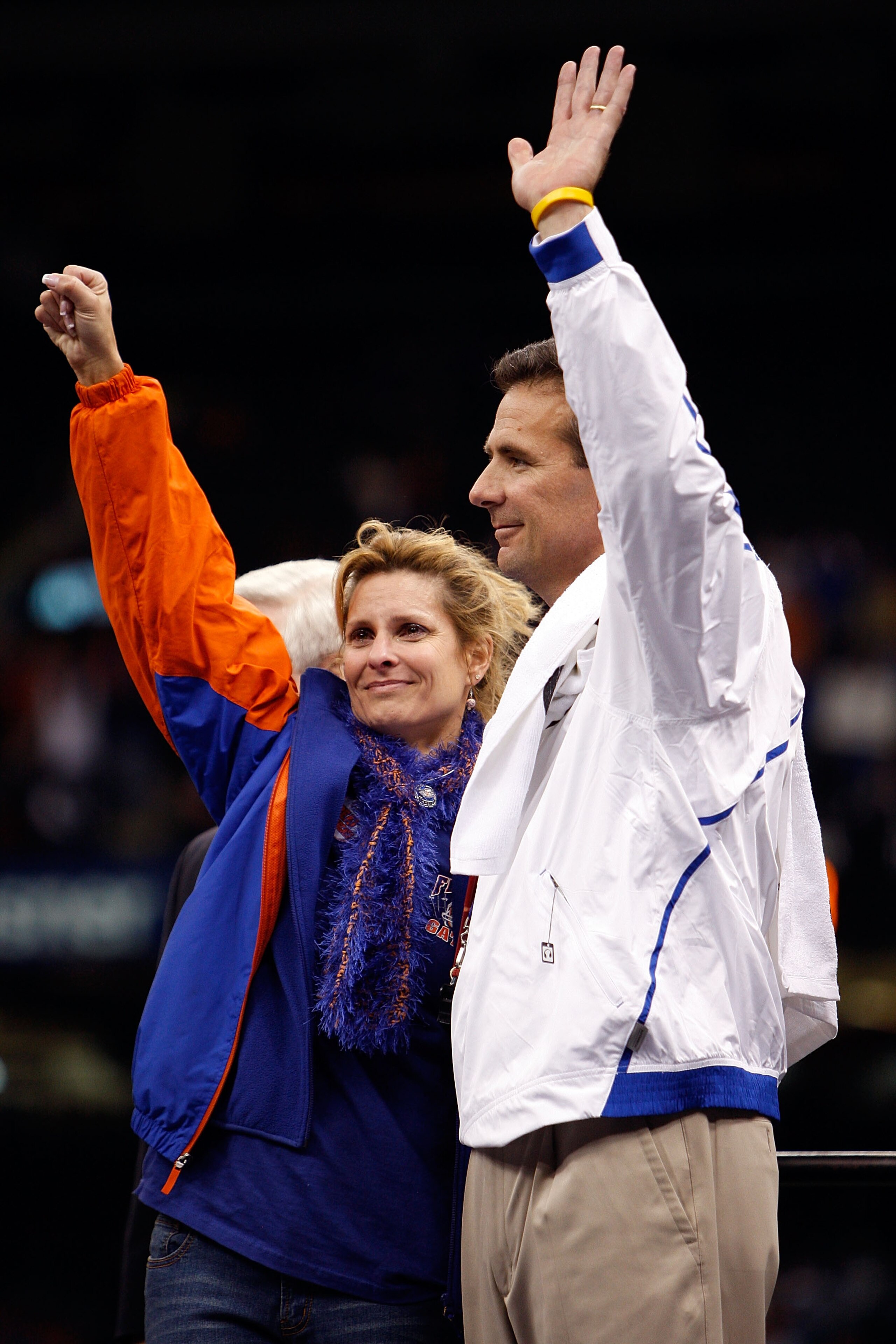 NEW ORLEANS - JANUARY 01:  Head coach Urban Meyer (R) of the Florida Gators waves to the crowd with his wife Shelley Mather Meyer on the field after the Gators defeated the Cincinnati Bearcats 24-51 in the Allstate Sugar Bowl at the Louisana Superdome on