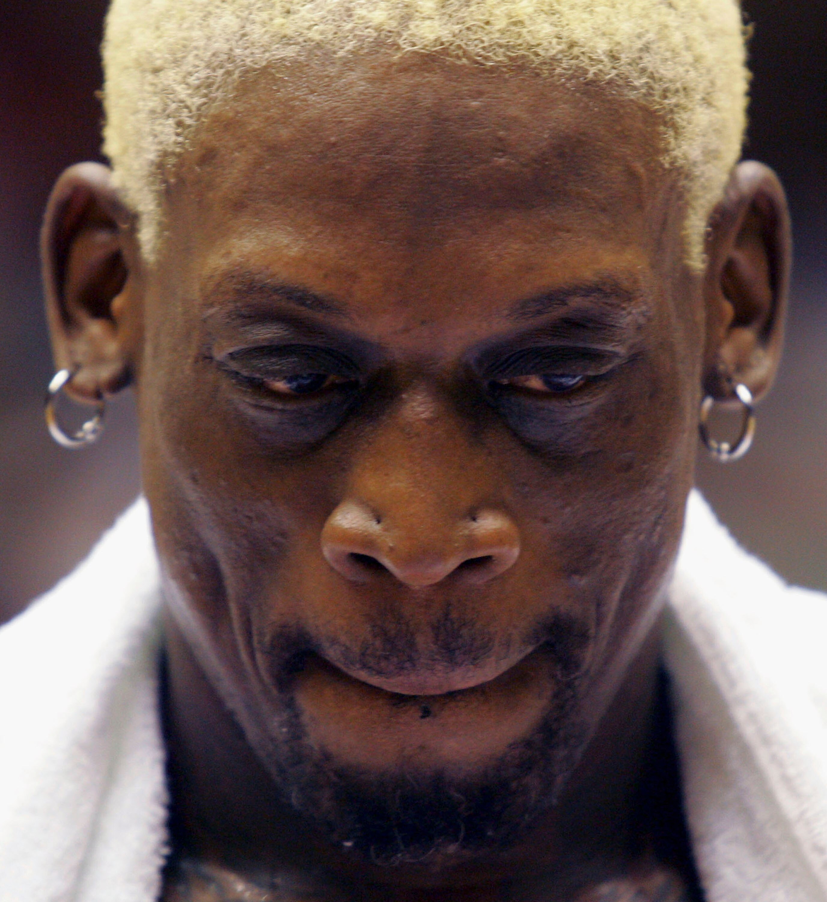 WUHAN, CHINA - AUGUST 12: (CHINA OUT) Former NBA star Dennis Rodman rests during an exhibition match between former NBA players and the US university students All-star Team on August 12, 2005 in Wuhan of Hubei Province, central China. Dennis Rodman is vis