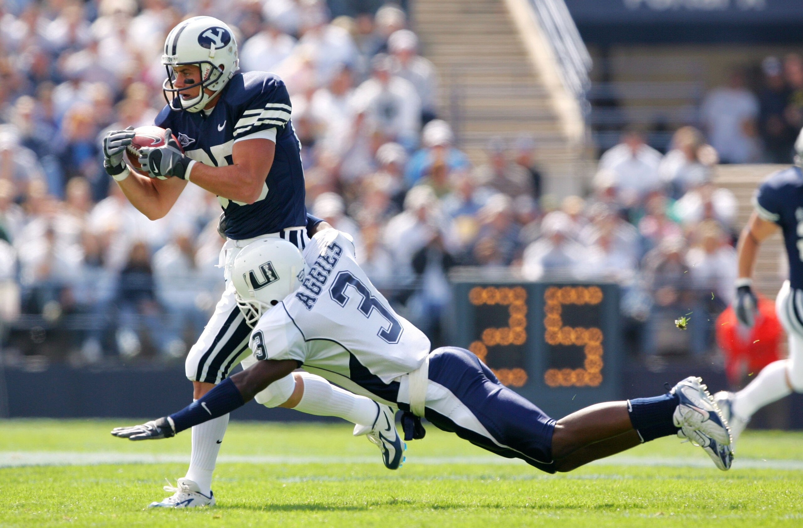 PROVO, UT - SEPTEMBER 23:  Zac Collie #85 of the Brigham Young Cougars catches the ball against Marquise Charles #3 of the Utah State Aggies on September 23, 2006 at La Vell Edwards Stadium in Provo, Utah.  (Photo By Kent Horner/Getty Images)