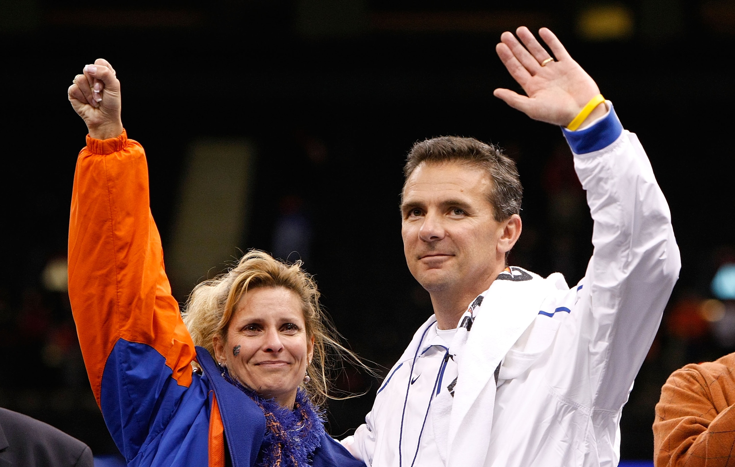 NEW ORLEANS - JANUARY 01:  Head coach Urban Meyer (R) of the Florida Gators waves to the crowd with his wife Shelley Mather Meyer on the field after the Gators defeated the Cincinnati Bearcats 24-51 in the Allstate Sugar Bowl at the Louisana Superdome on
