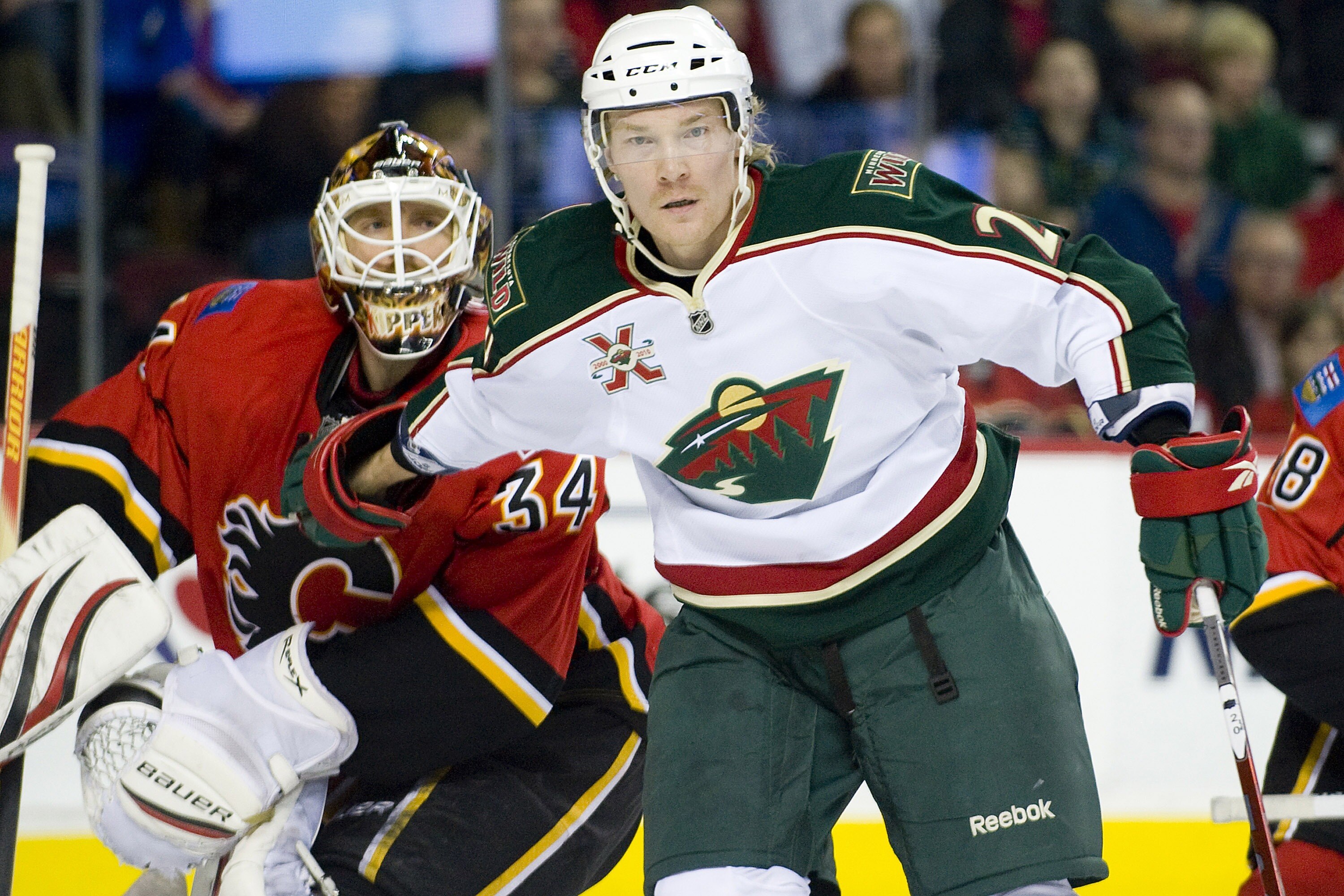 EDMONTON, AB - NOVEMBER 29:  Antti Miettinen #20 of the Minnesota Wild pushes his way past Miikka Kiprusoff #34 of the Calgary Flames at Scotiabank Saddledome on November 29, 2010 in Calgary, Alberta, Canada. The Flames beat the Wild 3-0.  (Photo by Dylan
