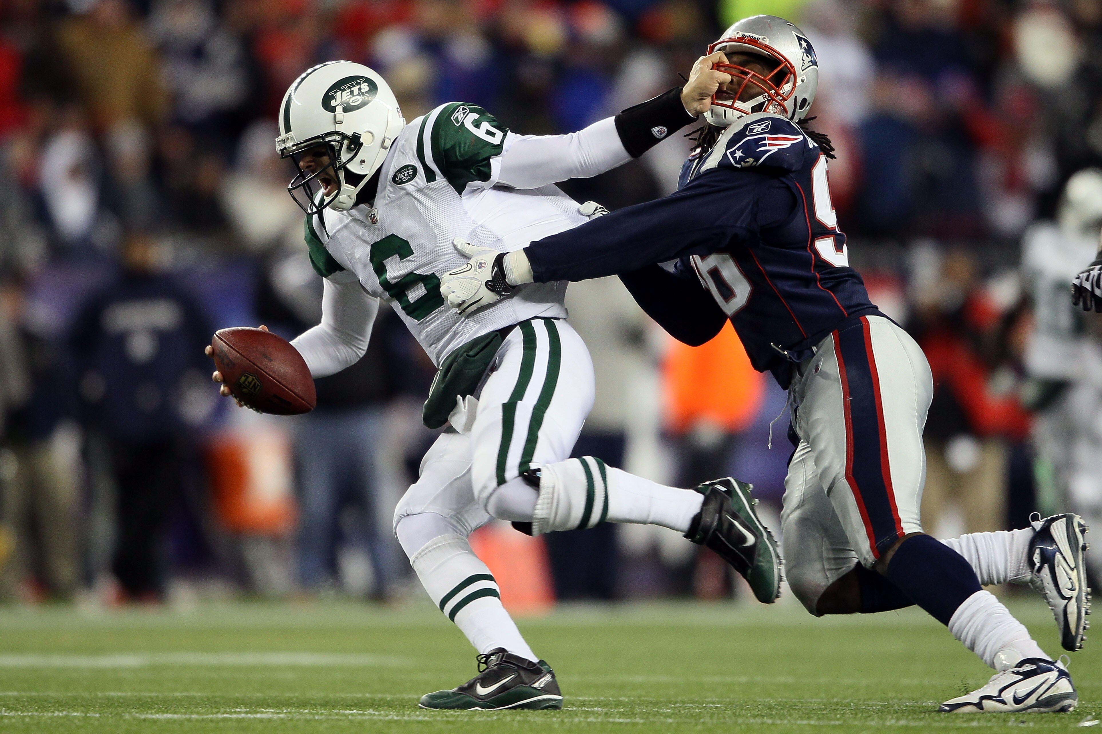 FOXBORO, MA - DECEMBER 06:  Mark Sanchez #6 of the New York Jets attempts to escape the pass rush of Jermaine Cunningham #96 of the New England Patriots at Gillette Stadium on December 6, 2010 in Foxboro, Massachusetts.  (Photo by Elsa/Getty Images)