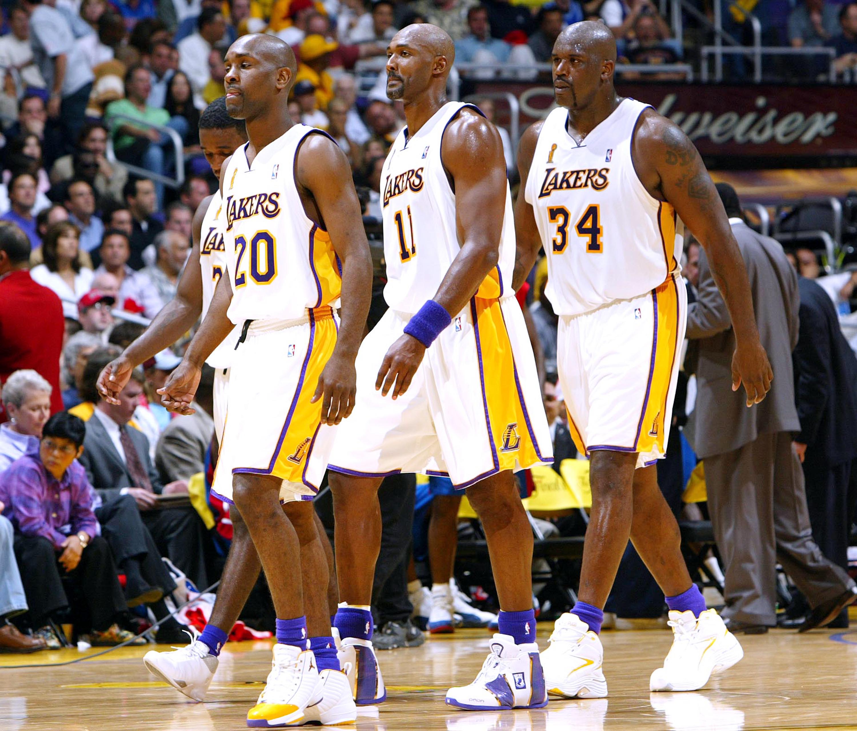 LOS ANGELES - JUNE 6:  Gary Payton #20, Kareem Rush #21, Karl Malone #11 and Shaquille O'Neal #34 of the Los Angeles Lakers walk off the court in Game 1 of the 2004 NBA Finals against the Detroit Pistons on June 6, 2004 at Staples Center in Los Angeles, C