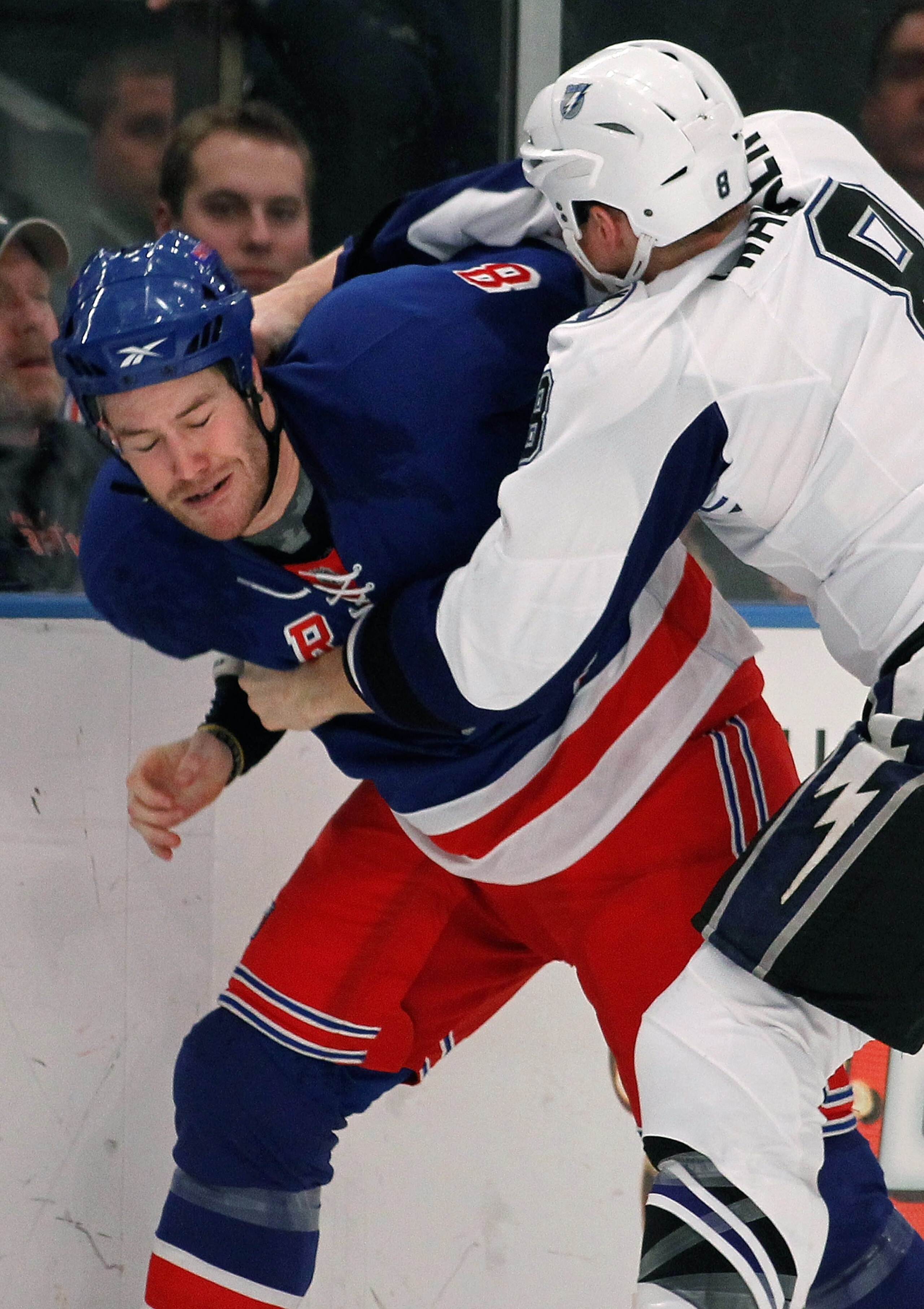 NEW YORK - FEBRUARY 14:  Brandon Prust #8 of the New York Rangers is hit by Matt Walker #8 of the Tampa Bay Lightning in a fight as each player received a major fighting penalty during the first period of an NHL game at Madison Square Garden on February 1