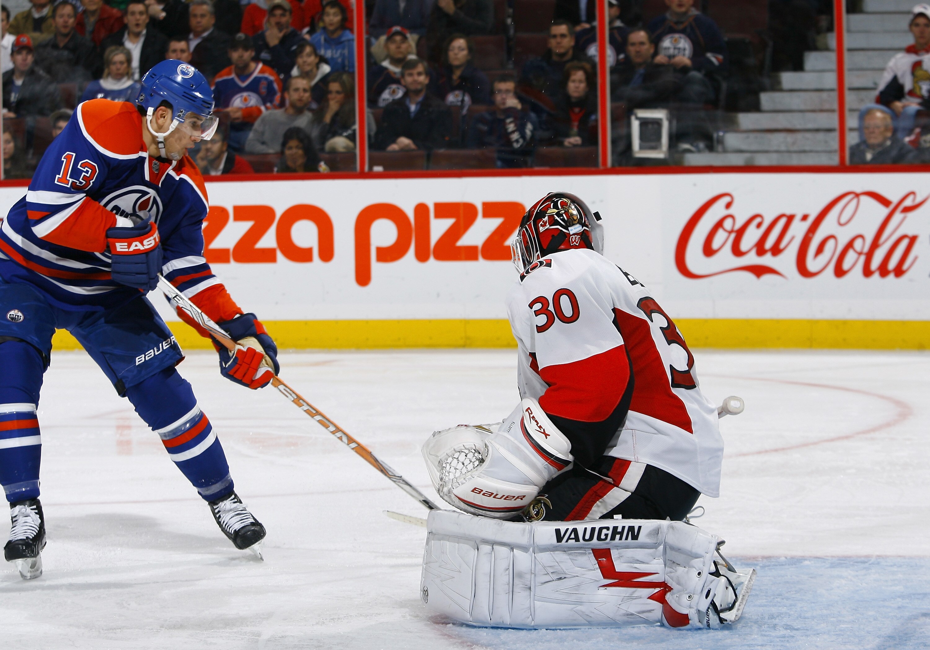 OTTAWA, ON - NOVEMBER 29:   Andrew Cogliano #13 of the Edmonton Oilers just misses a pass out front of Brian Elliott #30 of the Ottawa Senators in a game at Scotiabank Place on November 29, 2010 in Ottawa, Ontario, Canada.  The Edmonton Oilers defeated th