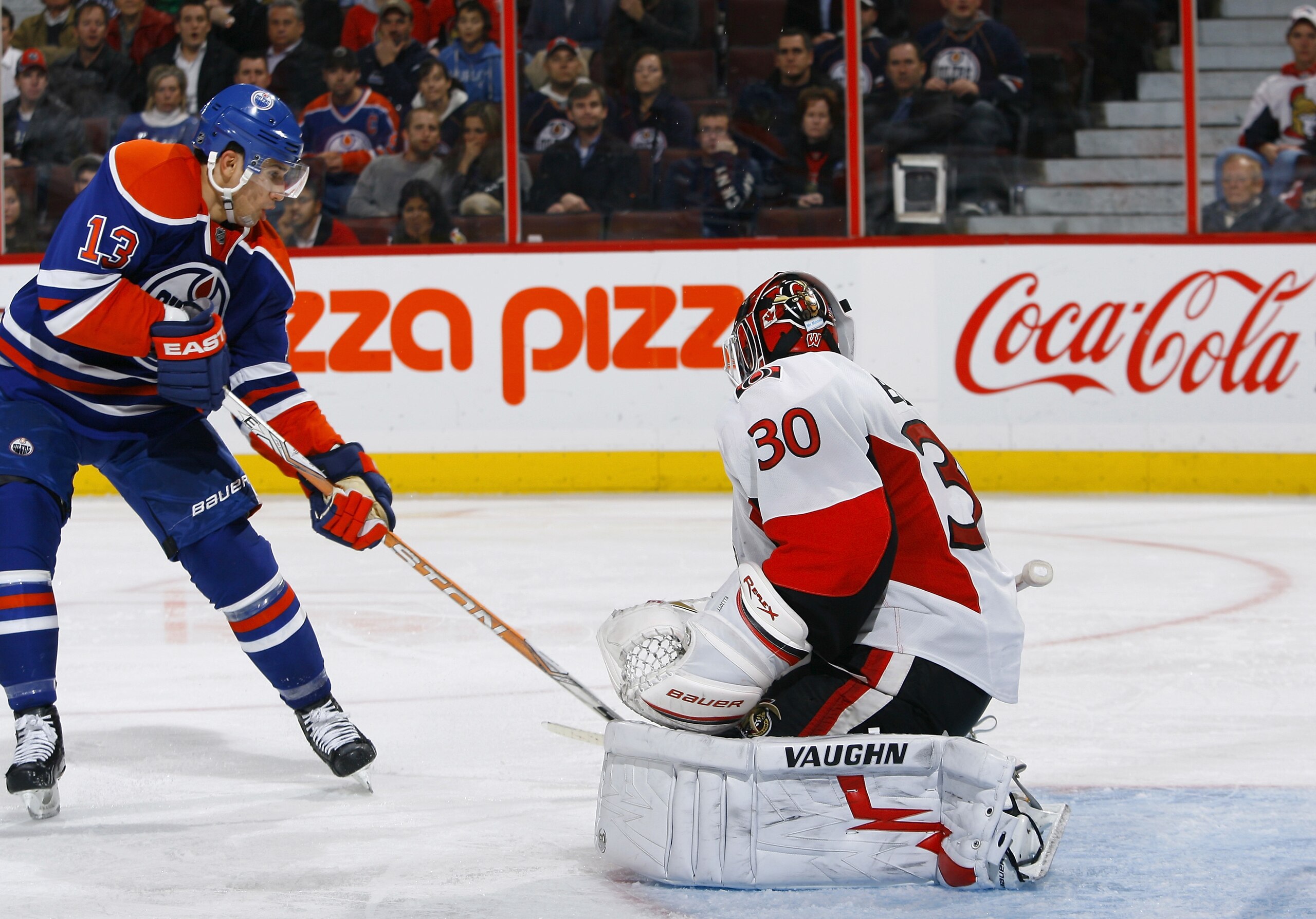 OTTAWA, ON - NOVEMBER 29:   Andrew Cogliano #13 of the Edmonton Oilers just misses a pass out front of Brian Elliott #30 of the Ottawa Senators in a game at Scotiabank Place on November 29, 2010 in Ottawa, Ontario, Canada.  The Edmonton Oilers defeated th