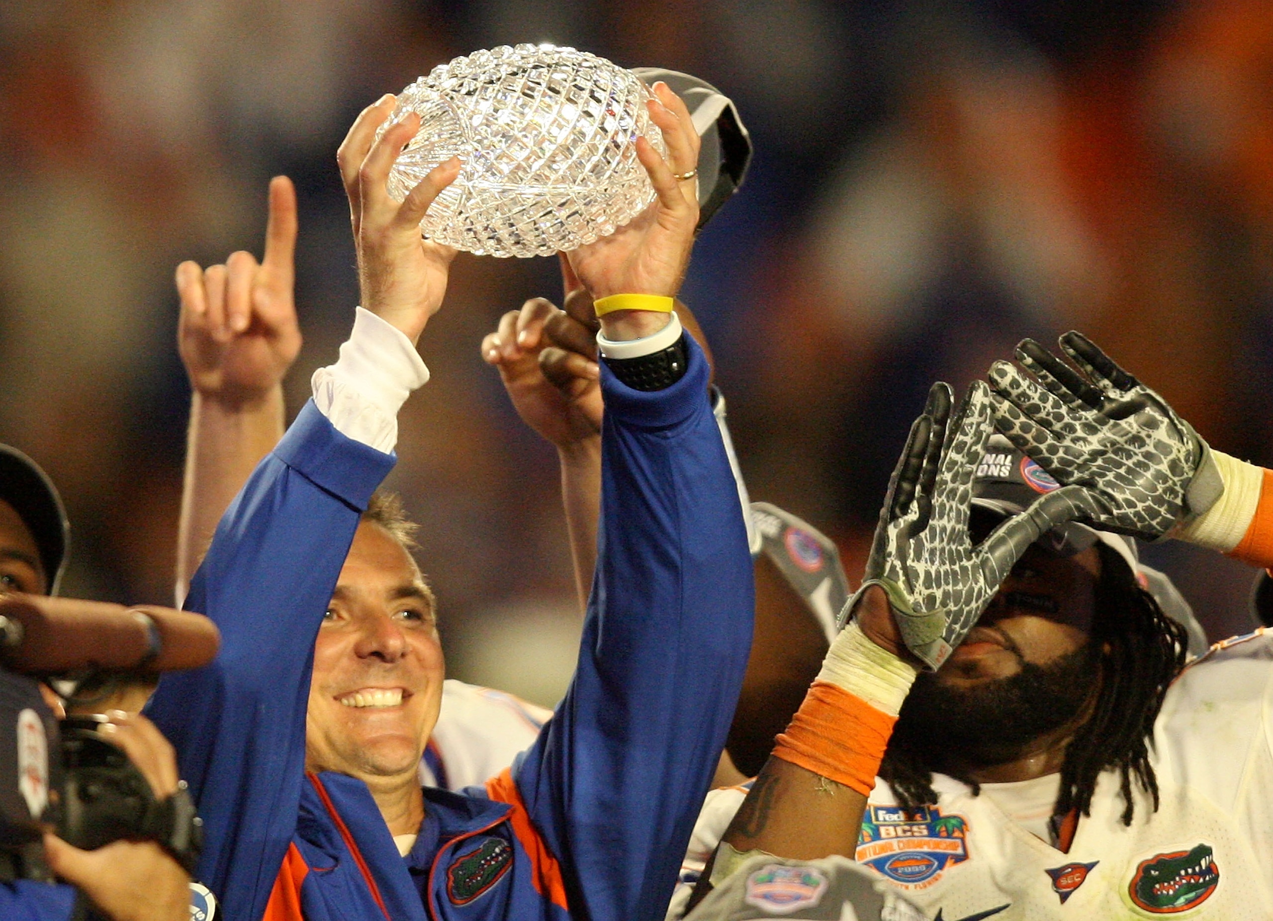 MIAMI - JANUARY 08:  Head coach Urban Meyer of the Florida Gators celebrates with the National Championship trophy after therir 24-14 win against the Oklahoma Sooners during the FedEx BCS National Championship game at Dolphin Stadium on January 8, 2009 in