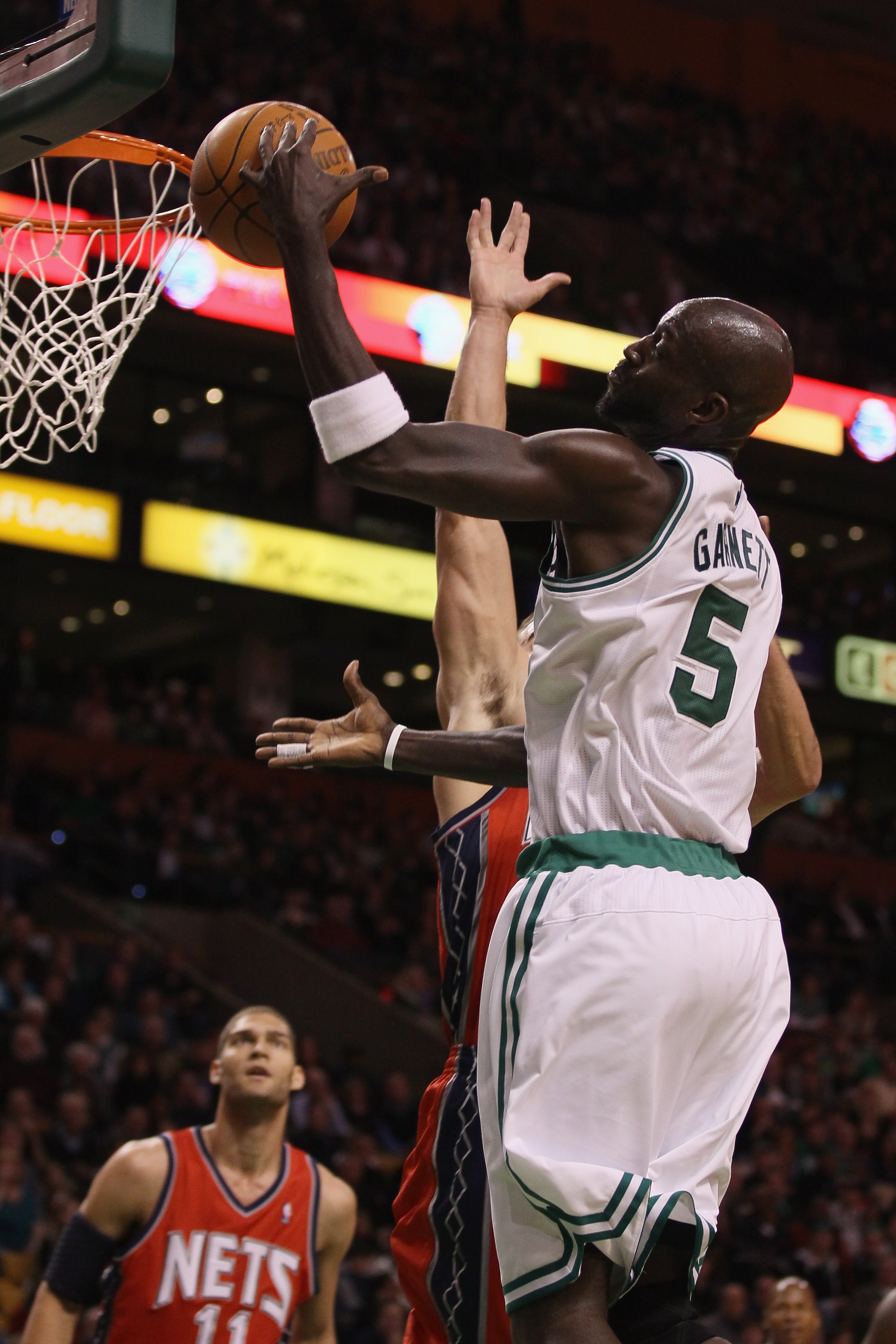 BOSTON - NOVEMBER 24:  Kevin Garnett #5 of the Boston Celtics loses the ball as Kris Humphries #43 of the New Jersey Nets defends on November 24, 2010 at the TD Garden in Boston, Massachusetts. NOTE TO USER: User expressly acknowledges and agrees that, by