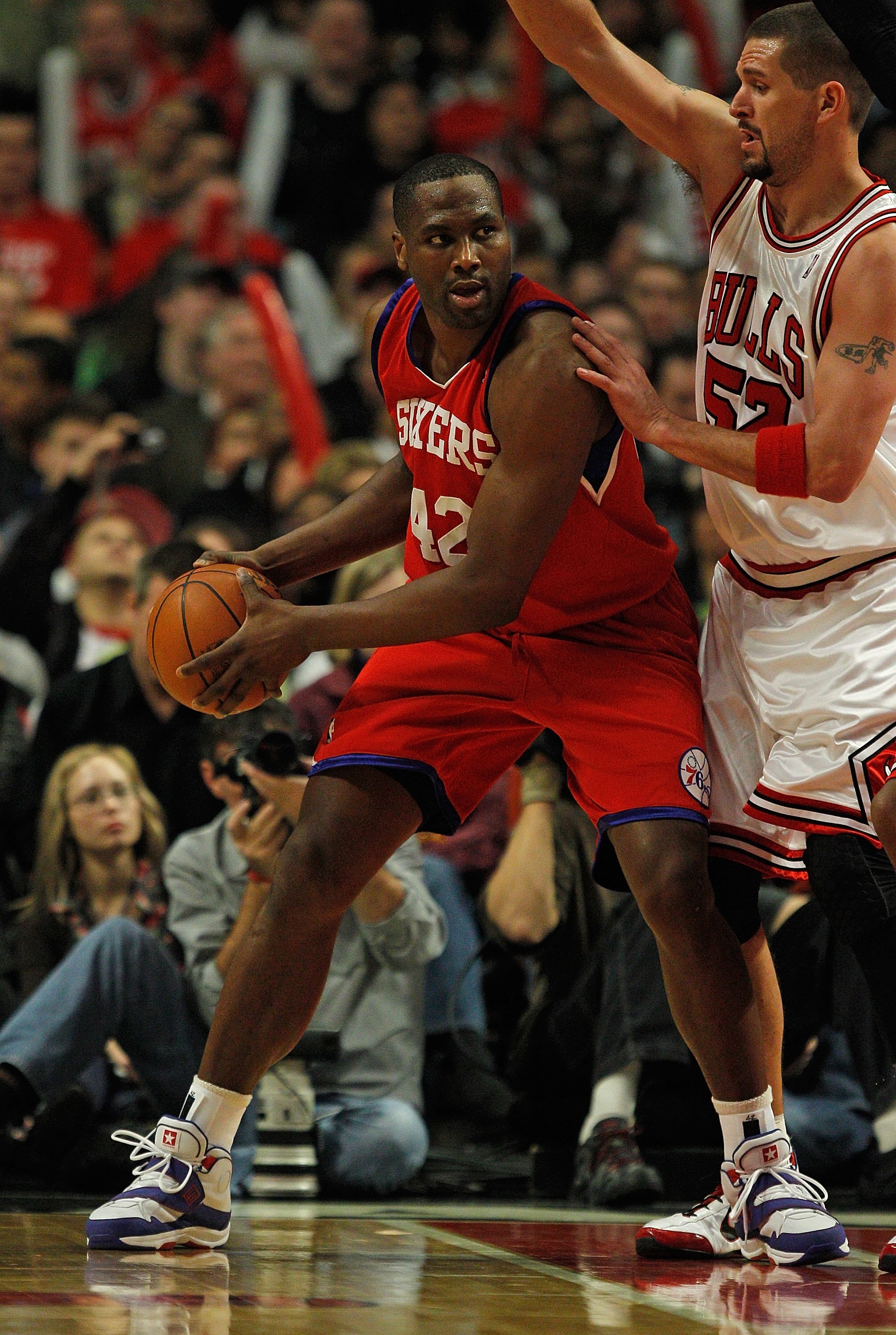 CHICAGO - FEBRUARY 20: Elton Brand #42 of the Philadelphia 76ers looks to pass under pressure from Brad Miller #52 of the Chicago Bulls at the United Center on February 20, 2010 in Chicago, Illinois. The Bulls defeated the 76ers 122-90. NOTE TO USER: User