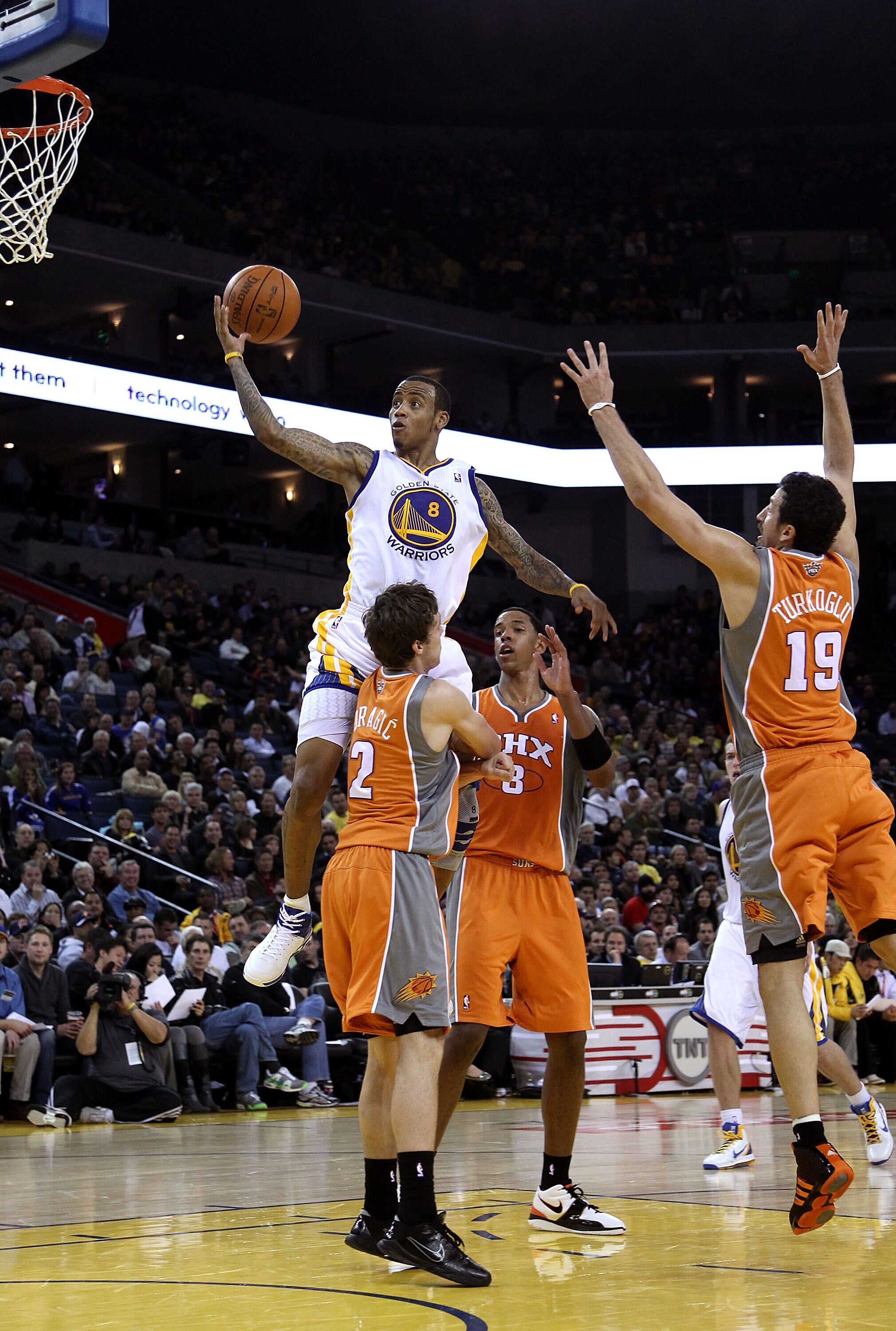 OAKLAND, CA - DECEMBER 02:  Monta Ellis #8 of the Golden State Warriors drives to the basket against the Phoenix Suns at Oracle Arena on December 2, 2010 in Oakland, California. NOTE TO USER: User expressly acknowledges and agrees that, by downloading and