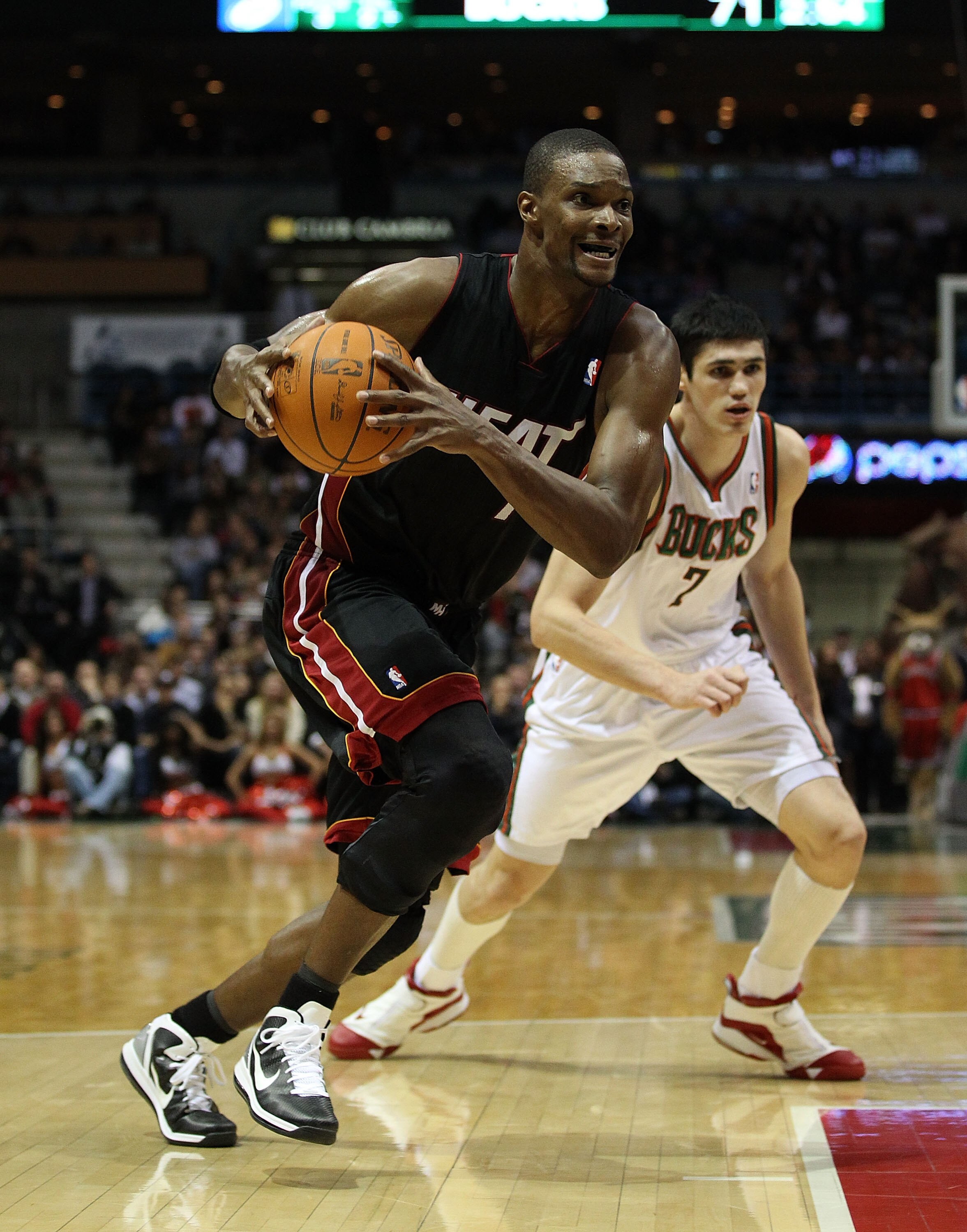 MILWAUKEE, WI - DECEMBER 06: Chris Bosh #1 of the Miami Heat drives past Ersan Ilyasova #7 of the Milwaukee Bucks at the Bradley Center on December 6, 2010 in Milwaukee, Wisconsin. The Heat defeated the Bucks 88-78. NOTE TO USER: User expressly acknowledg