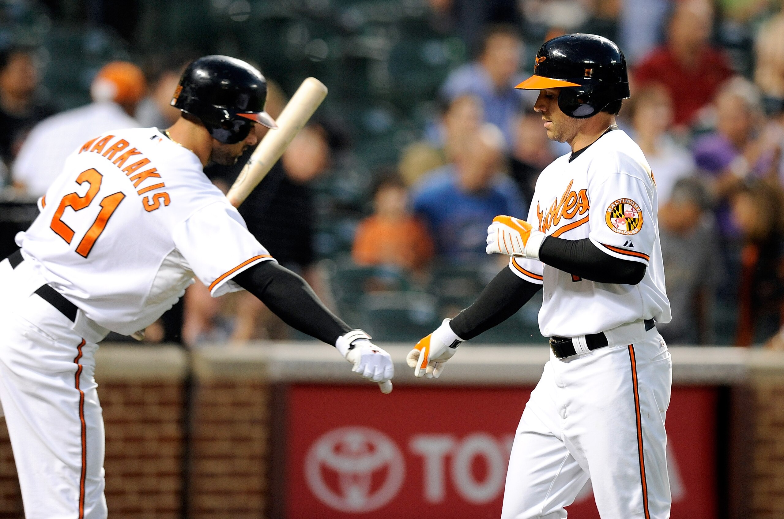 BALTIMORE - SEPTEMBER 13:  Brian Roberts #1 of the Baltimore Orioles is congratulated by Nick Markakis #21 after hitting a home run in the first inning against the Toronto Blue Jays at Camden Yards on September 13, 2010 in Baltimore, Maryland.  (Photo by 