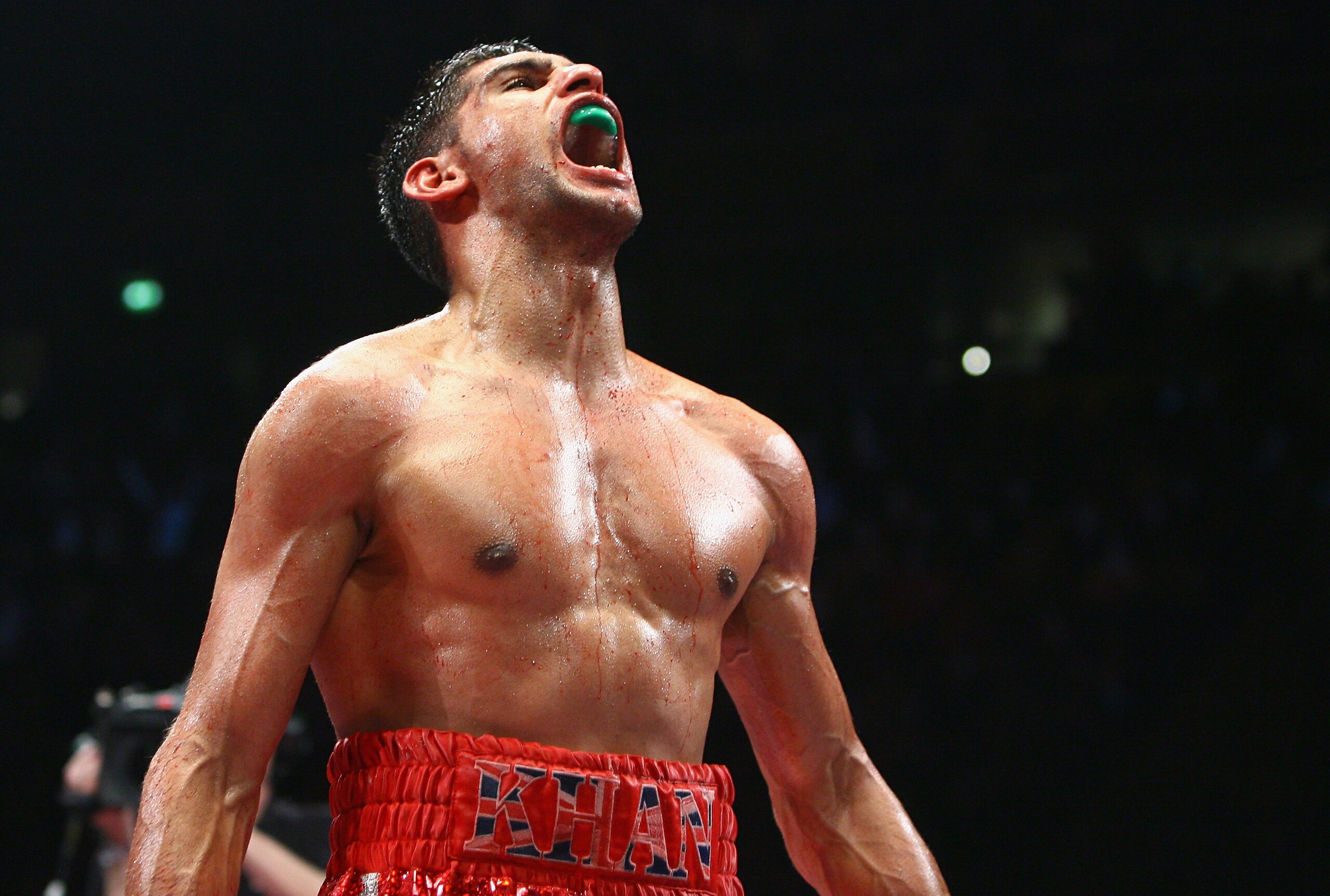 MANCHESTER, UNITED KINGDOM - MARCH 14:  Amir Khan celebrates victory during the WBA and WBO Inter-Continental Lightweight title fight between Amir Khan and Marc Antonio Barrera at the MEN Arena on March 14, 2009 in Manchester, England. (Photo by Alex Live