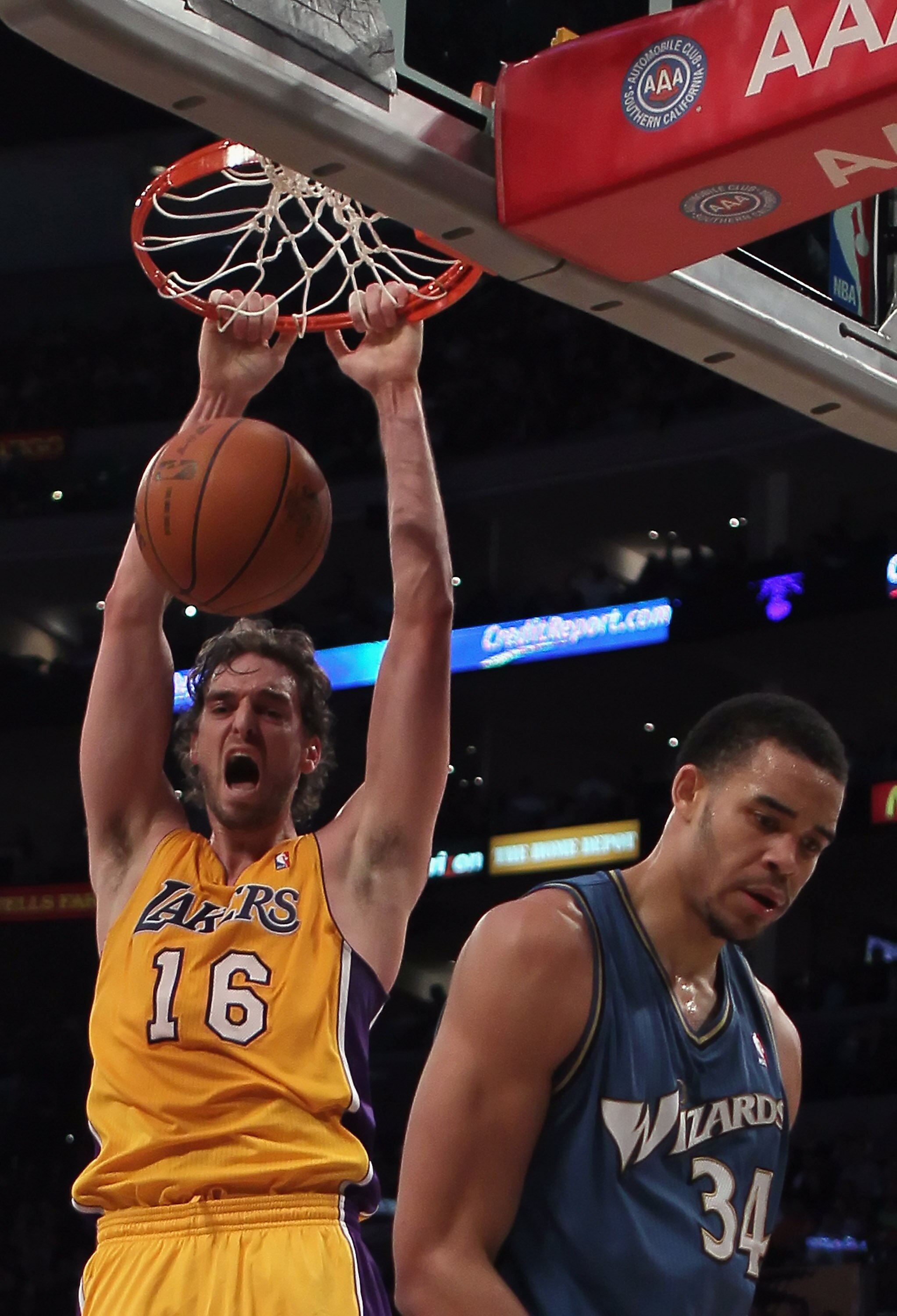 LOS ANGELES, CA - DECEMBER 07:  Pau Gasol #16 of the Los Angeles Lakers dunks over Javale McGee #34 of the Washington Wizards in the first half at Staples Center on December 7, 2010 in Los Angeles, California. The Lakers defeated the Wizards 115-108. NOTE